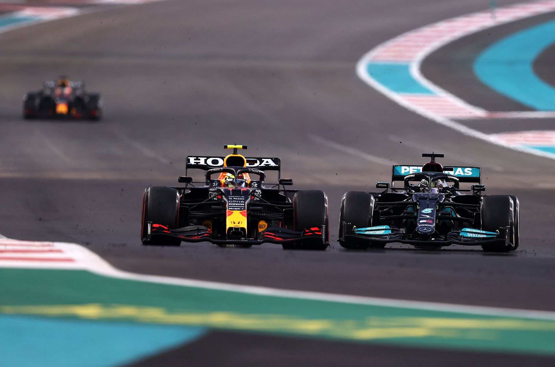 Sergio Perez (#11) Red Bull RB16B, holding off Lewis Hamilton (#44) Mercedes-AMG W13 on lap 21 of the 2021 Abu Dhabi Grand Prix (Photo by Lars Baron/Getty Images)