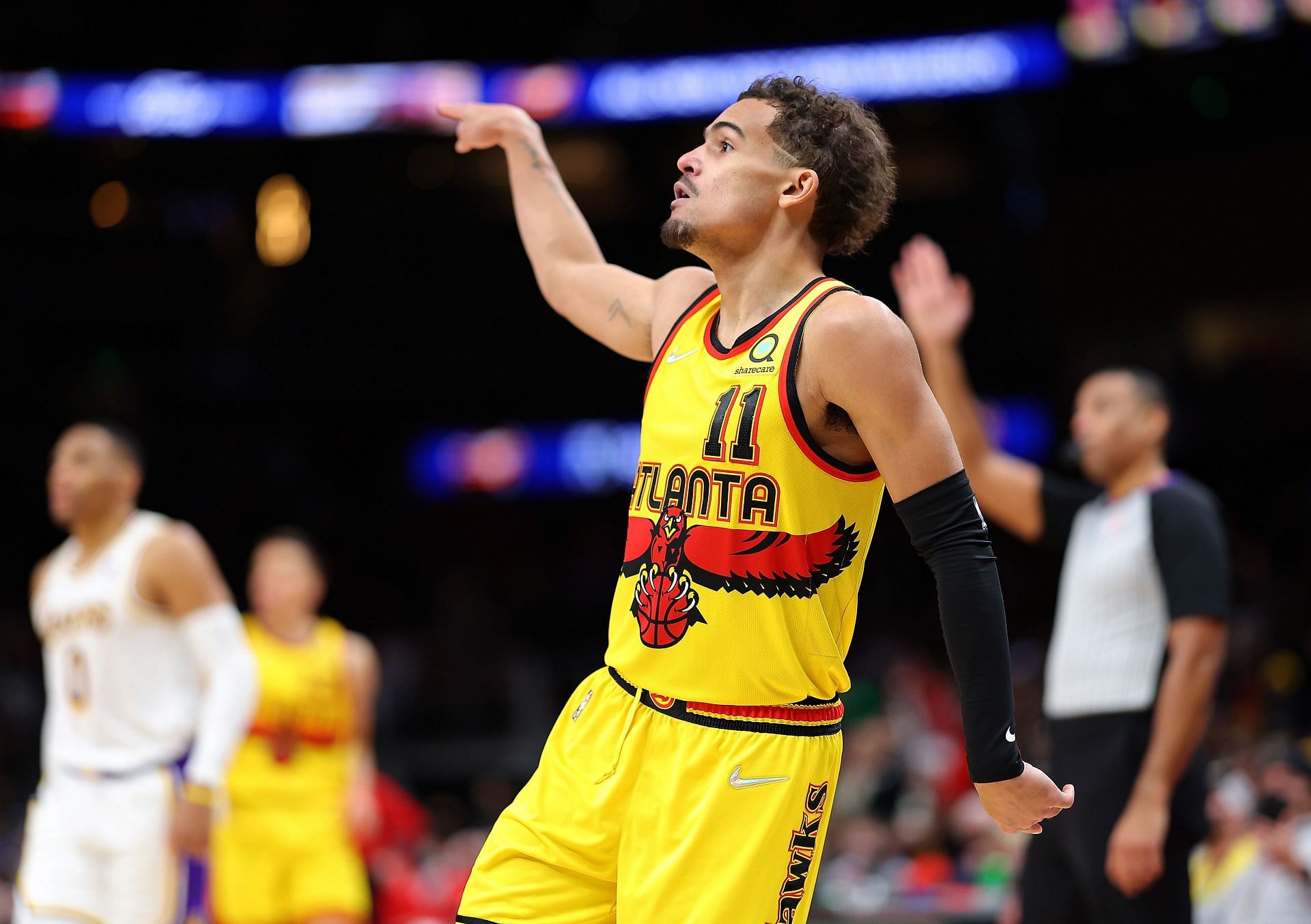 Trae Young #11 of the Atlanta Hawks reacts after shooting a three-point basket against the Los Angeles Lakers during the second half at State Farm Arena on January 30, 2022 in Atlanta, Georgia.