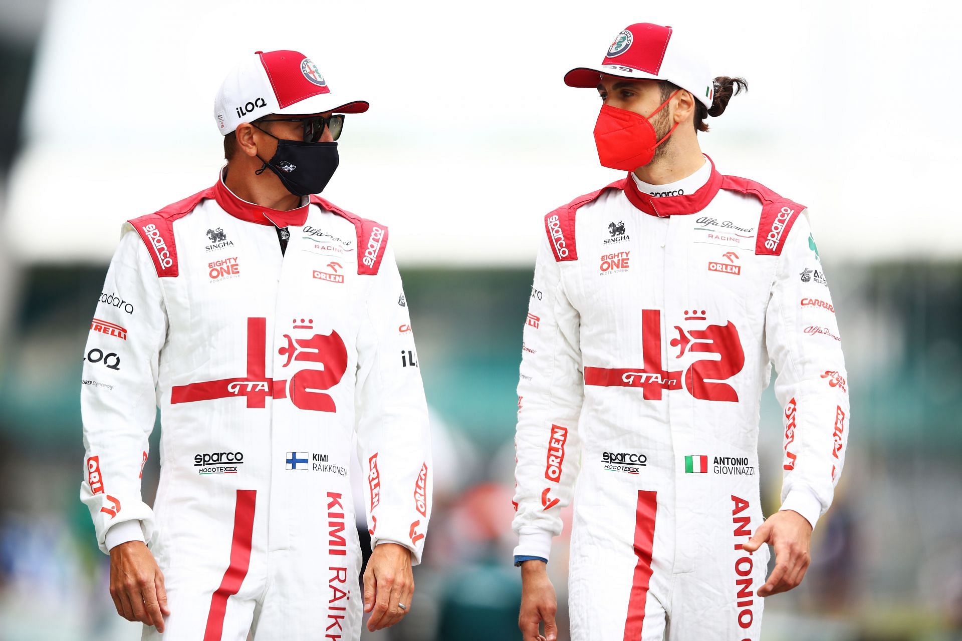 Kimi Raikkonen and Antonio Giovinazzi talk during previews ahead of the 2021 British GP. (Photo by Mark Thompson/Getty Images)
