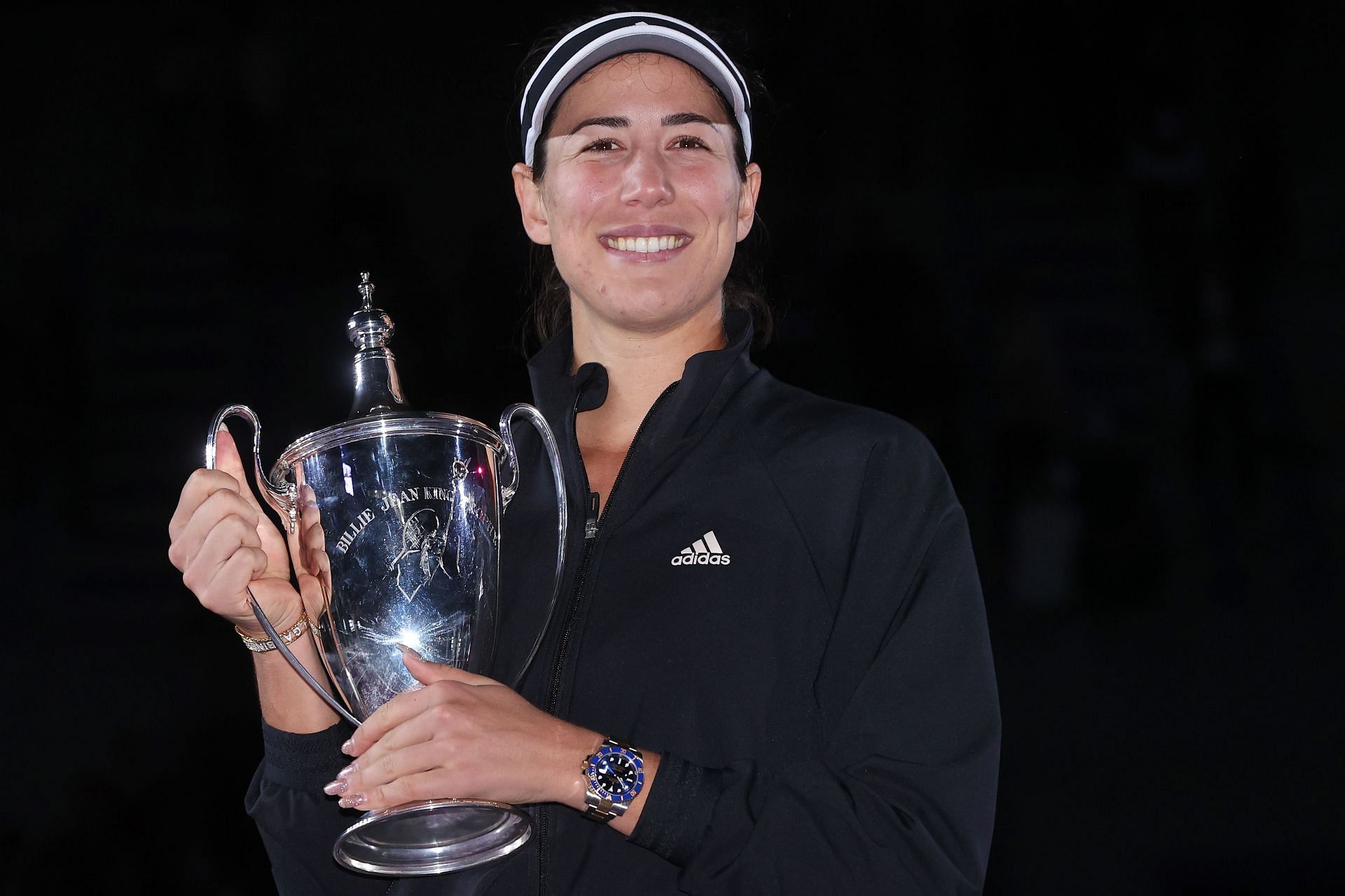 Garbine Muguruza poses with the Billie Jean King Trophy at the 2021 WTA Finals - Day 8