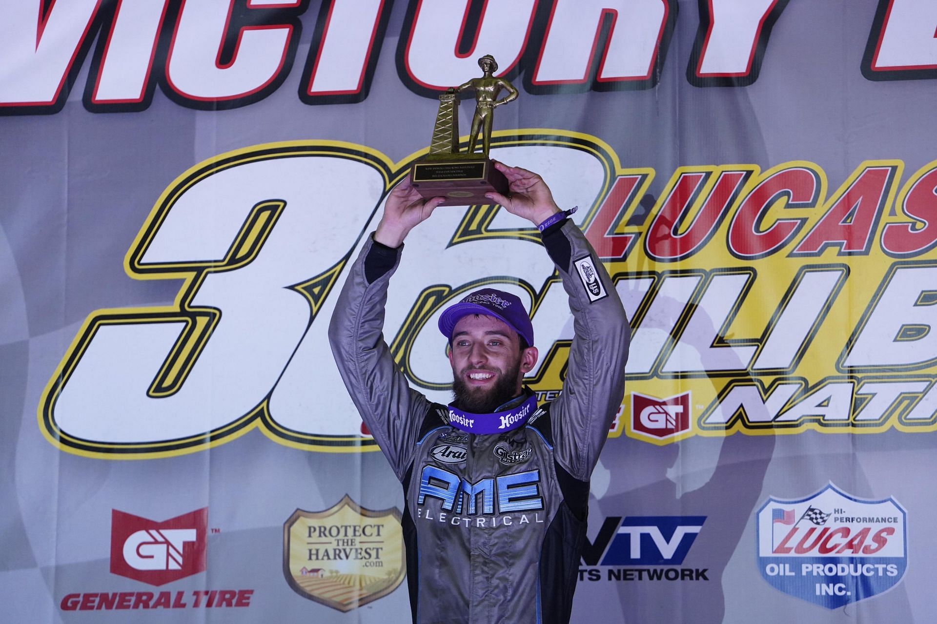 Tanner Thorson lifting his first-ever Golden Driller (Image via Twitter: @NASCAR)