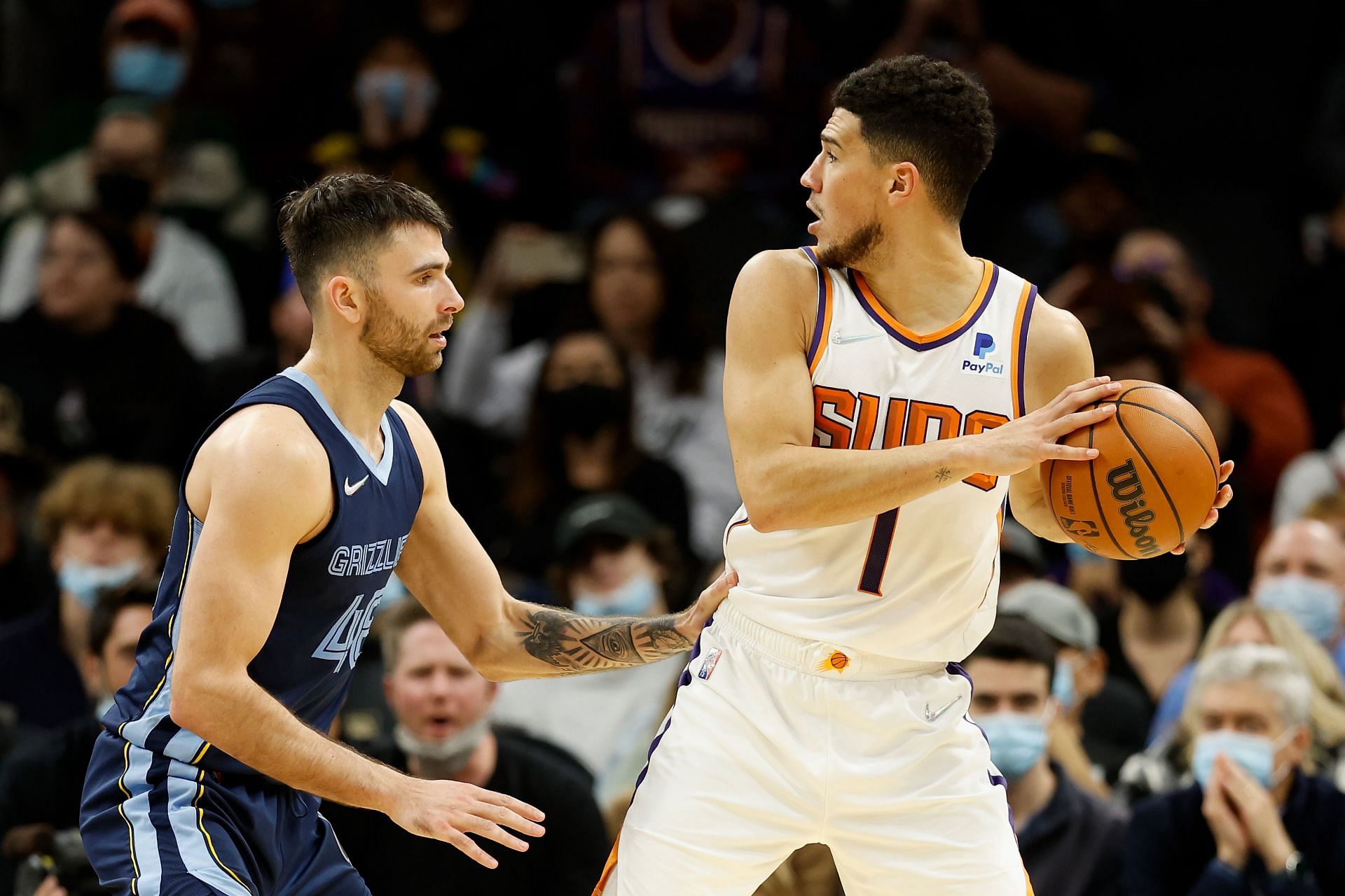 Devin Booker #1 of the Phoenix Suns looks to pass around John Konchar #46 of the Memphis Grizzlies