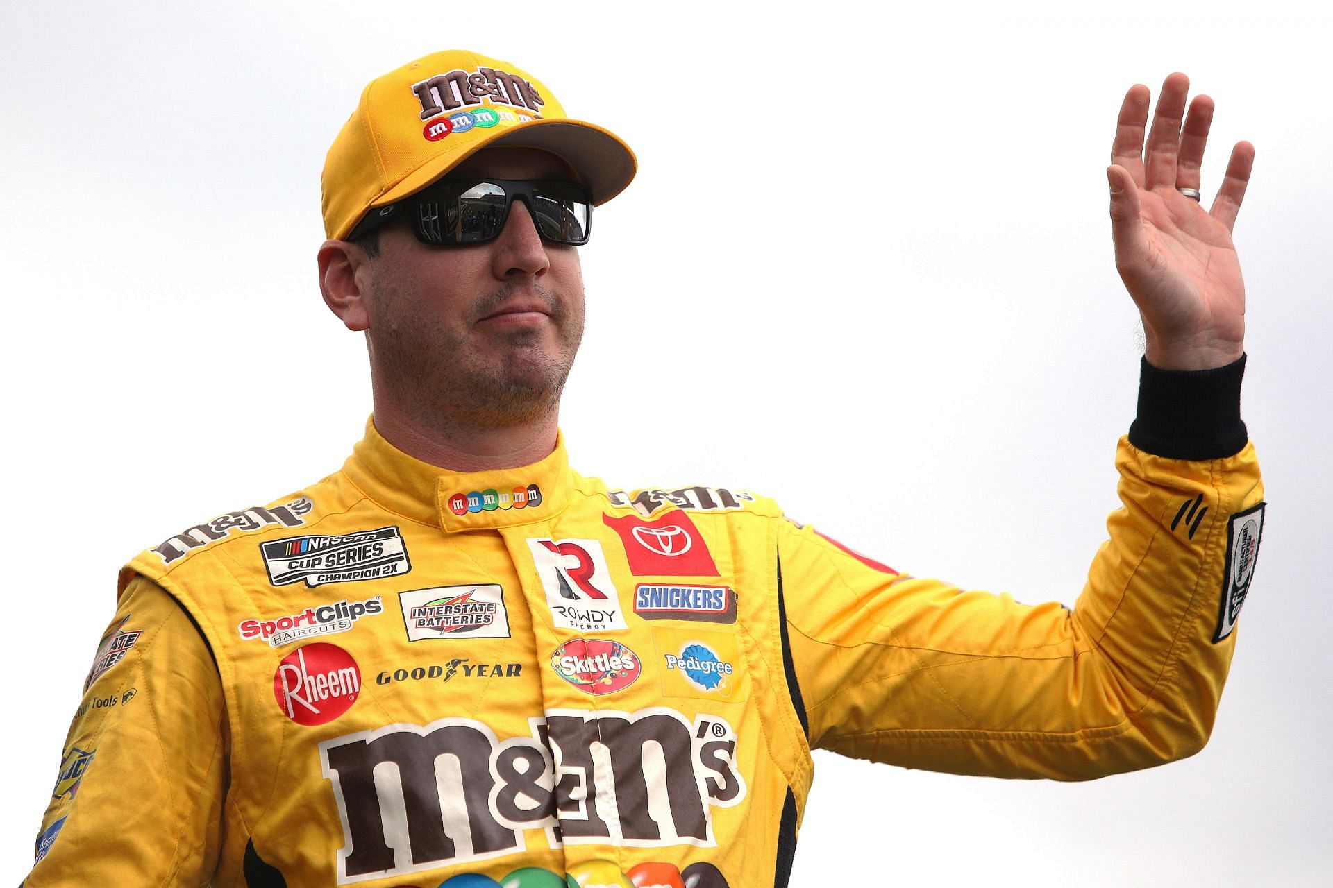 Kyle Busch waves to fans prior to the NASCAR Cup Series Hollywood Casino 400 at Kansas Speedway