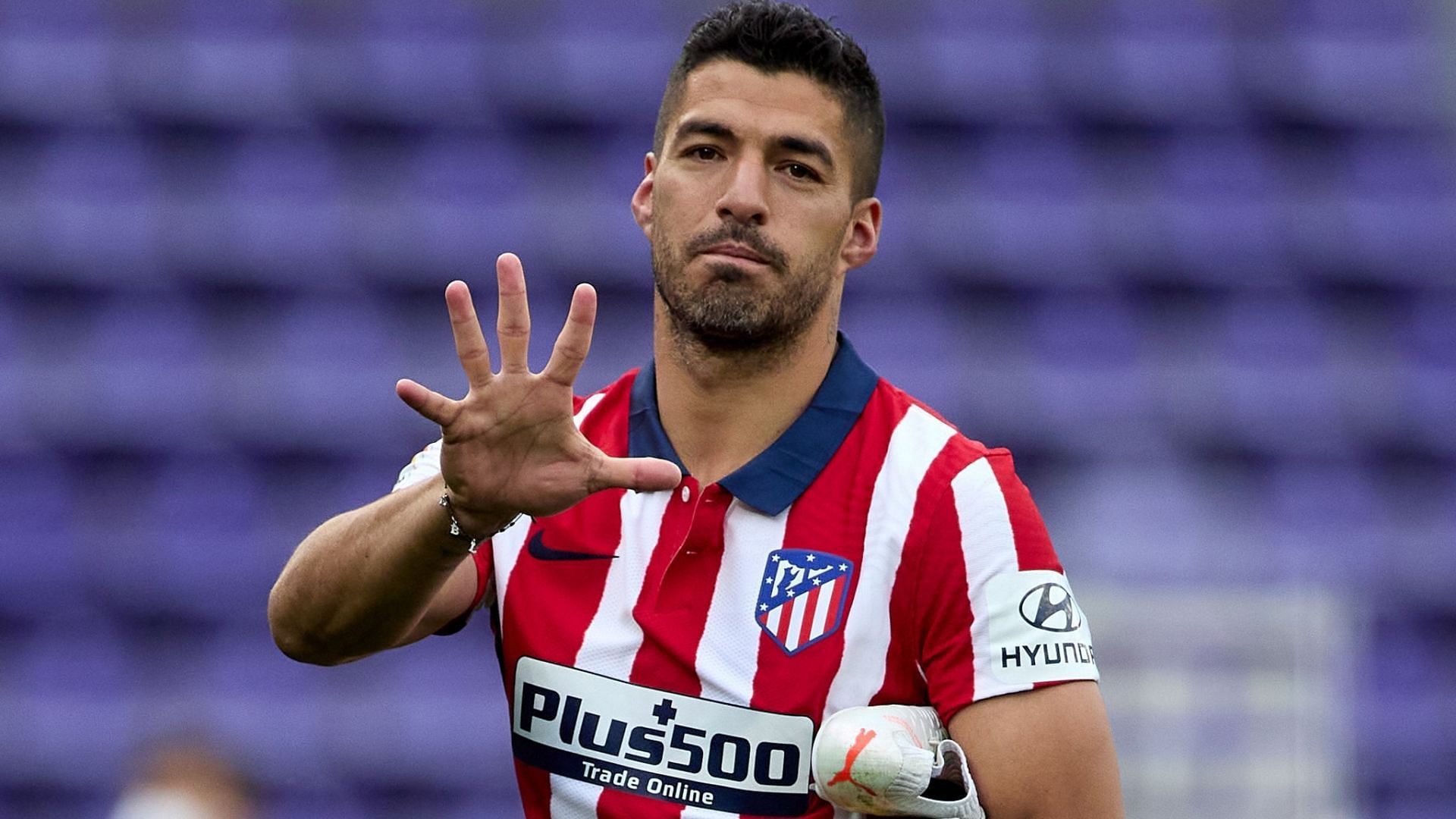 Luis Suarez gesturing towards the camera after scoring for Atletico Madrid.