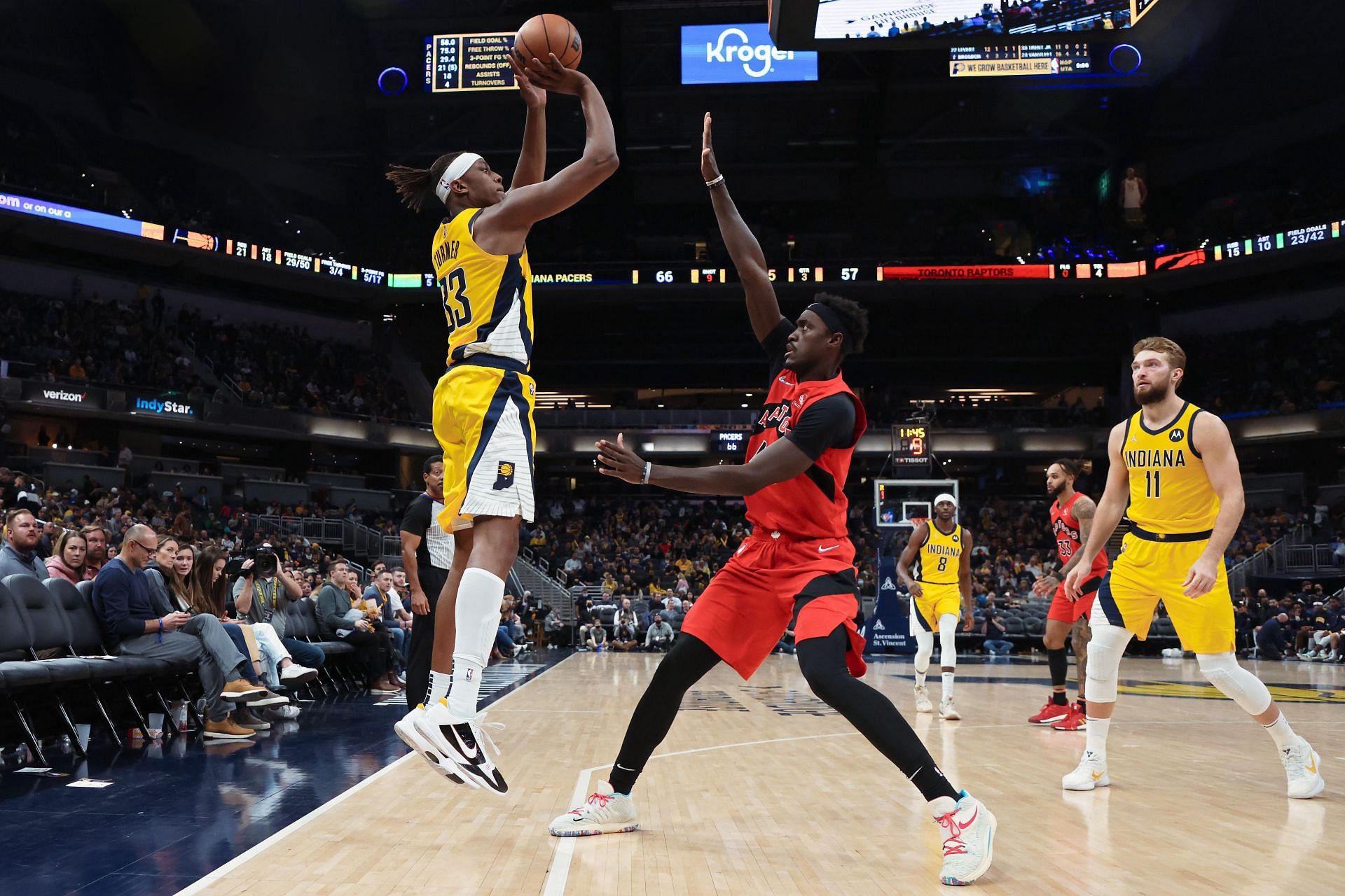 Myles Turner of the Pacers attempts a shot while being guarded by Pascal Siakam