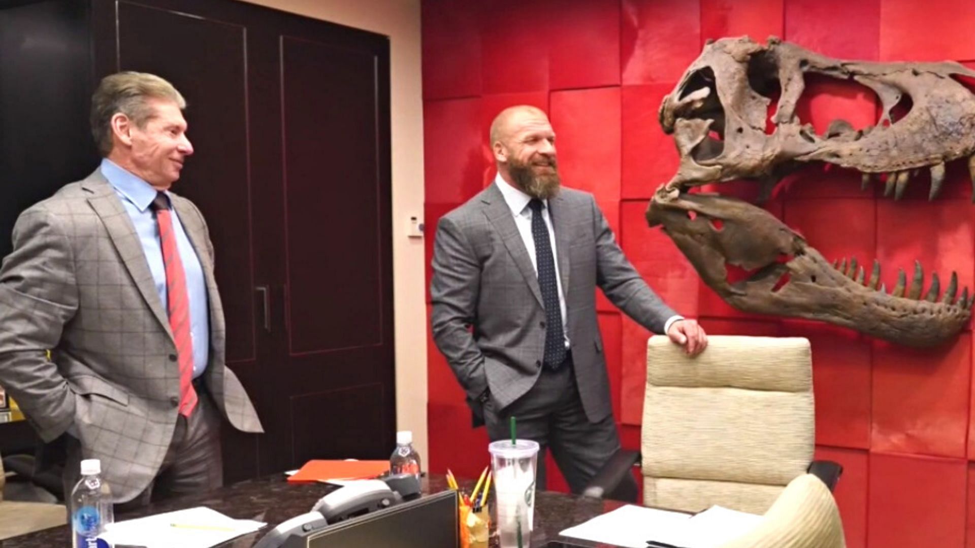 Vince McMahon with Triple H in his office.