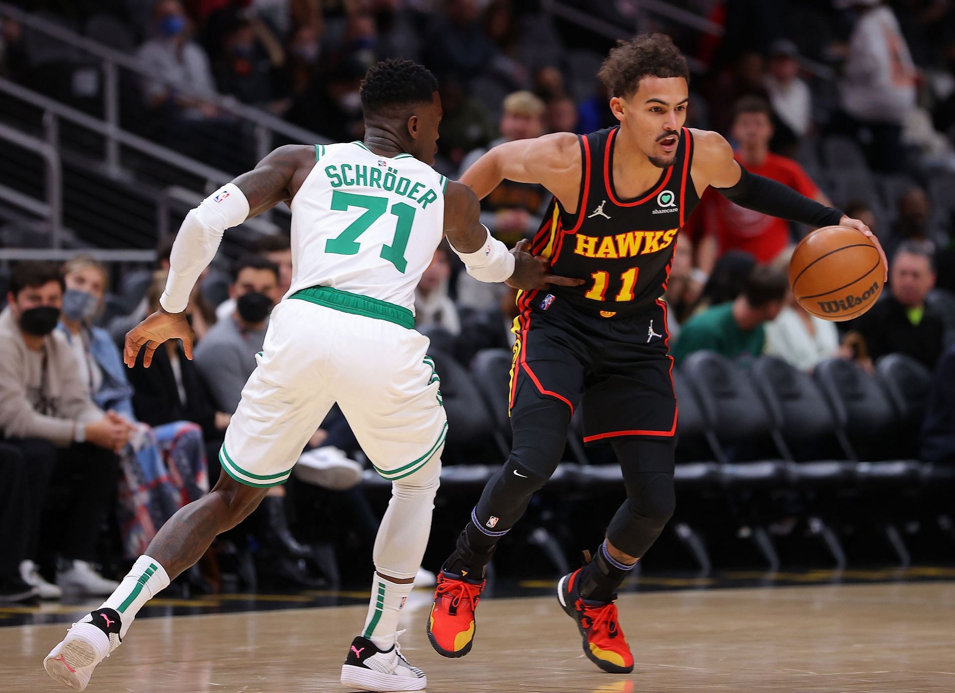 Trae Young #11 of the Atlanta Hawks drives against Dennis Schroder #71 of the Boston Celtics during the first half at State Farm Arena on November 17, 2021 in Atlanta, Georgia.