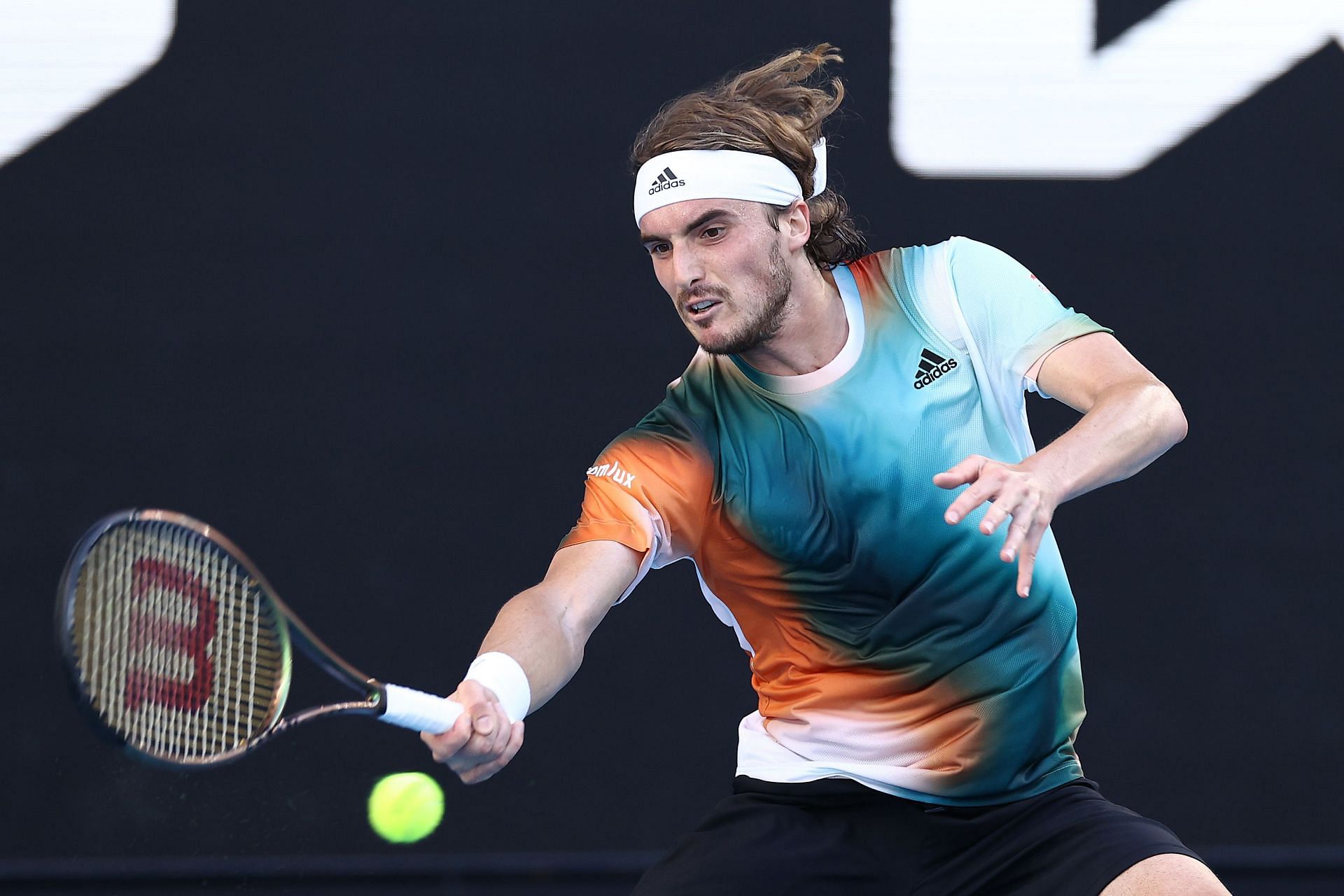 Stefanos Tsitsipas strikes a forehand at 2022 Australian Open