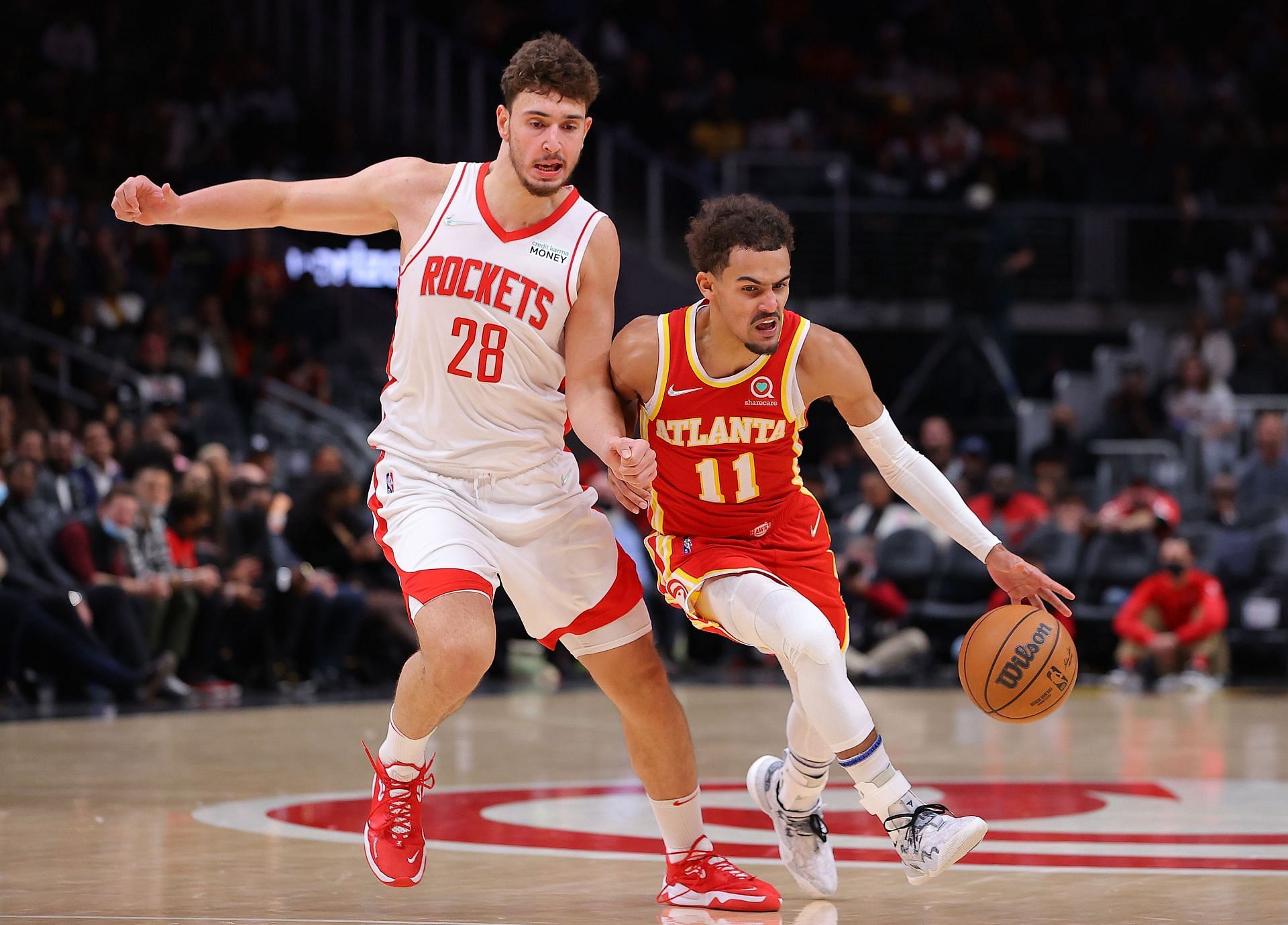 Trae Young #11 of the Atlanta Hawks drives against Alperen Sengun #28 of the Houston Rockets during the second half at State Farm Arena on December 13, 2021 in Atlanta, Georgia.