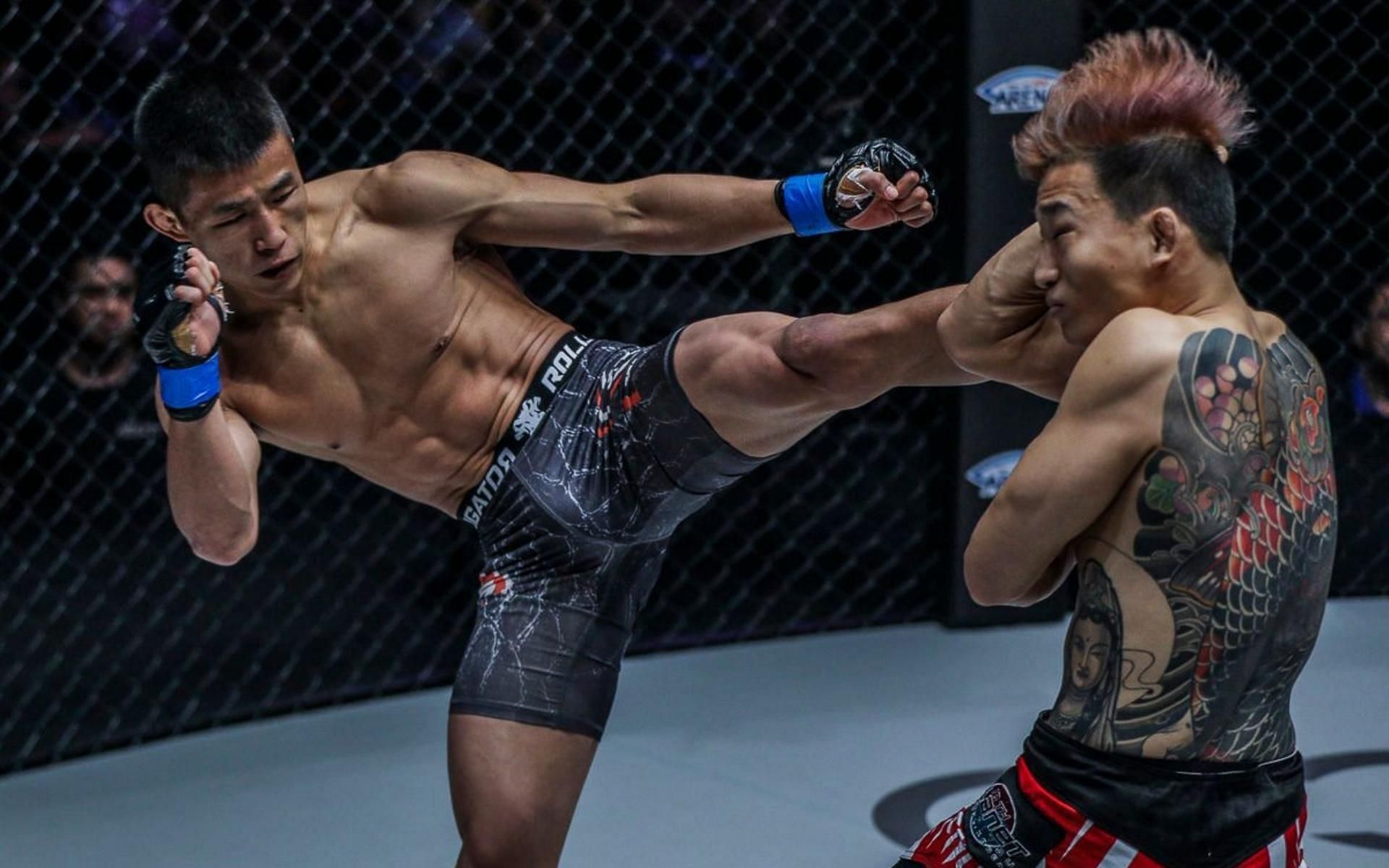 ONE Championship featherweight Tang Kai (left) landed a left kick from hell on Sung Jong Lee (right). (Image courtesy of ONE Championship)