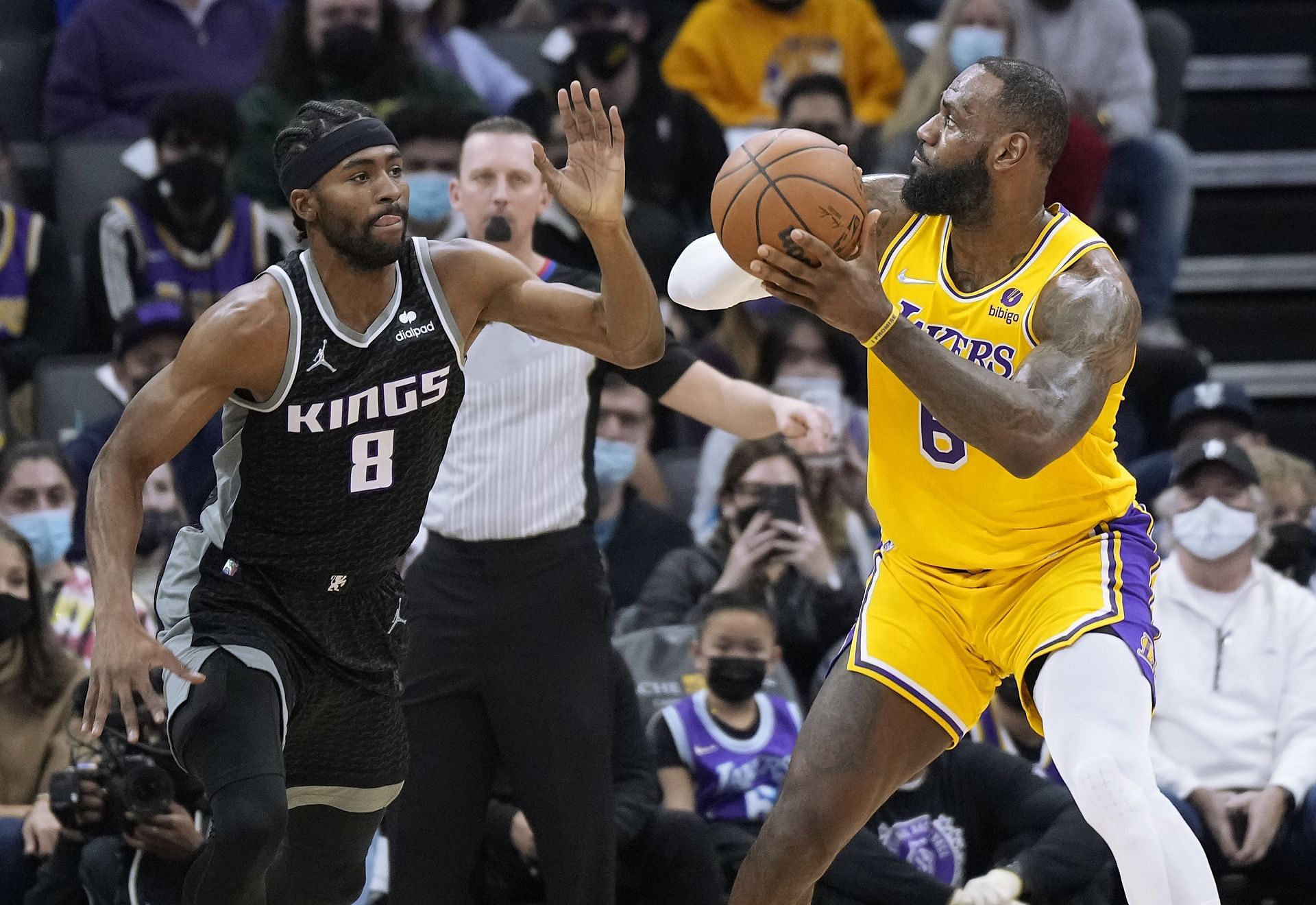 LeBron James #6 of the Los Angeles Lakers looks to shoot over Maurice Harkless #8 of the Sacramento Kings
