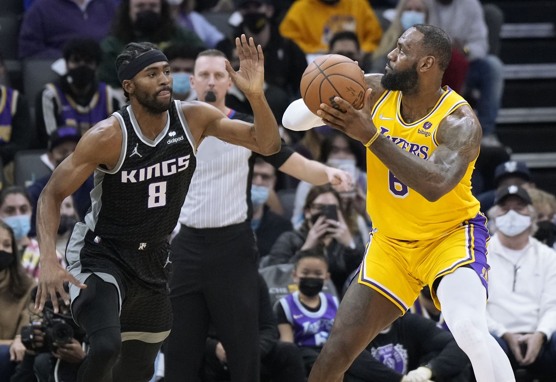 LeBron James #6 of the Los Angeles Lakers looks to shoot over Maurice Harkless #8 of the Sacramento Kings