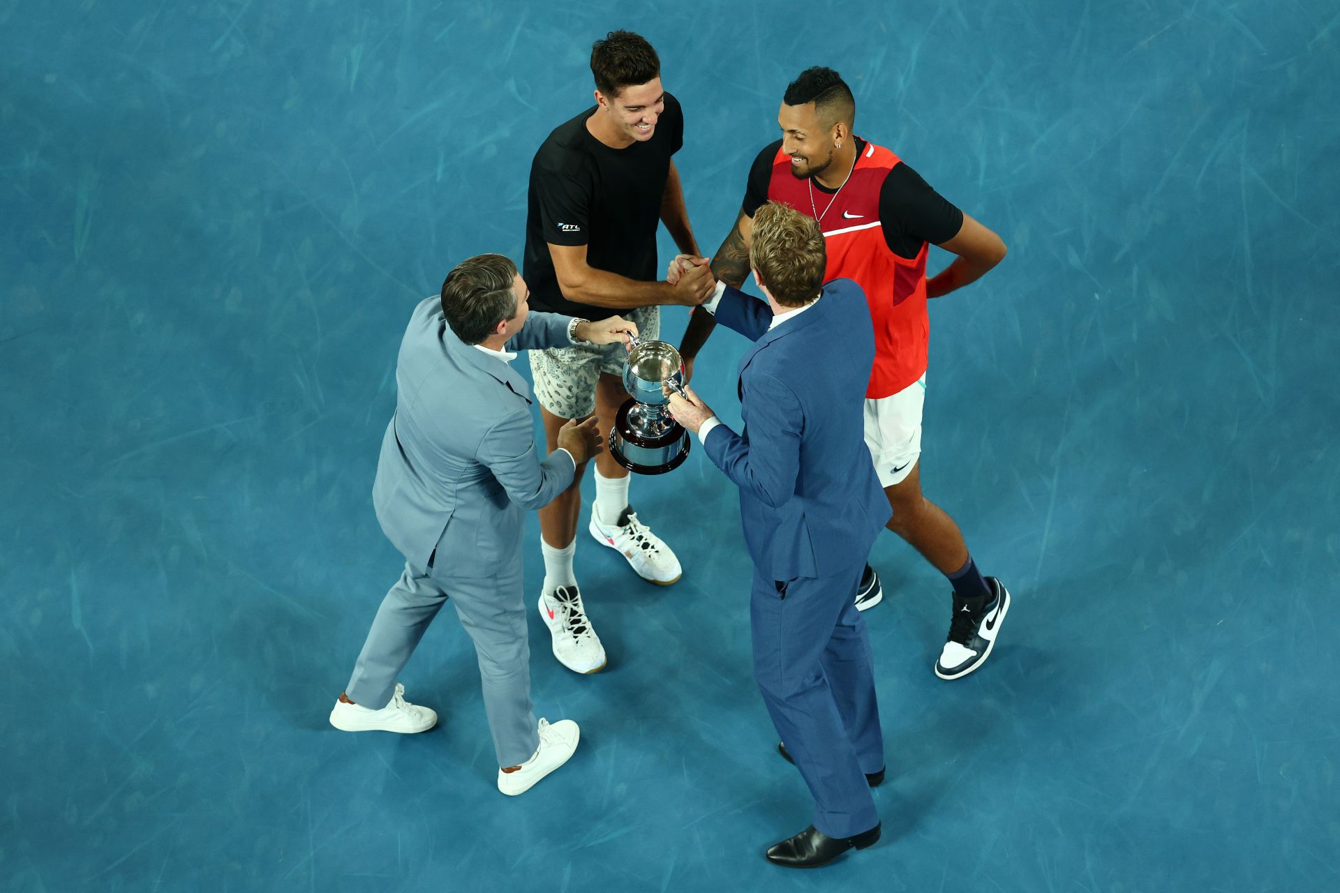 Kyrgios and Kokkinakis receiving the Men&#039;s doubles trophy from 1997 champions Tood Woodbridge and Mark Woodforde