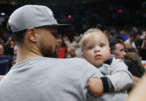 Steph Curry with his son Canon Curry during an NBA game