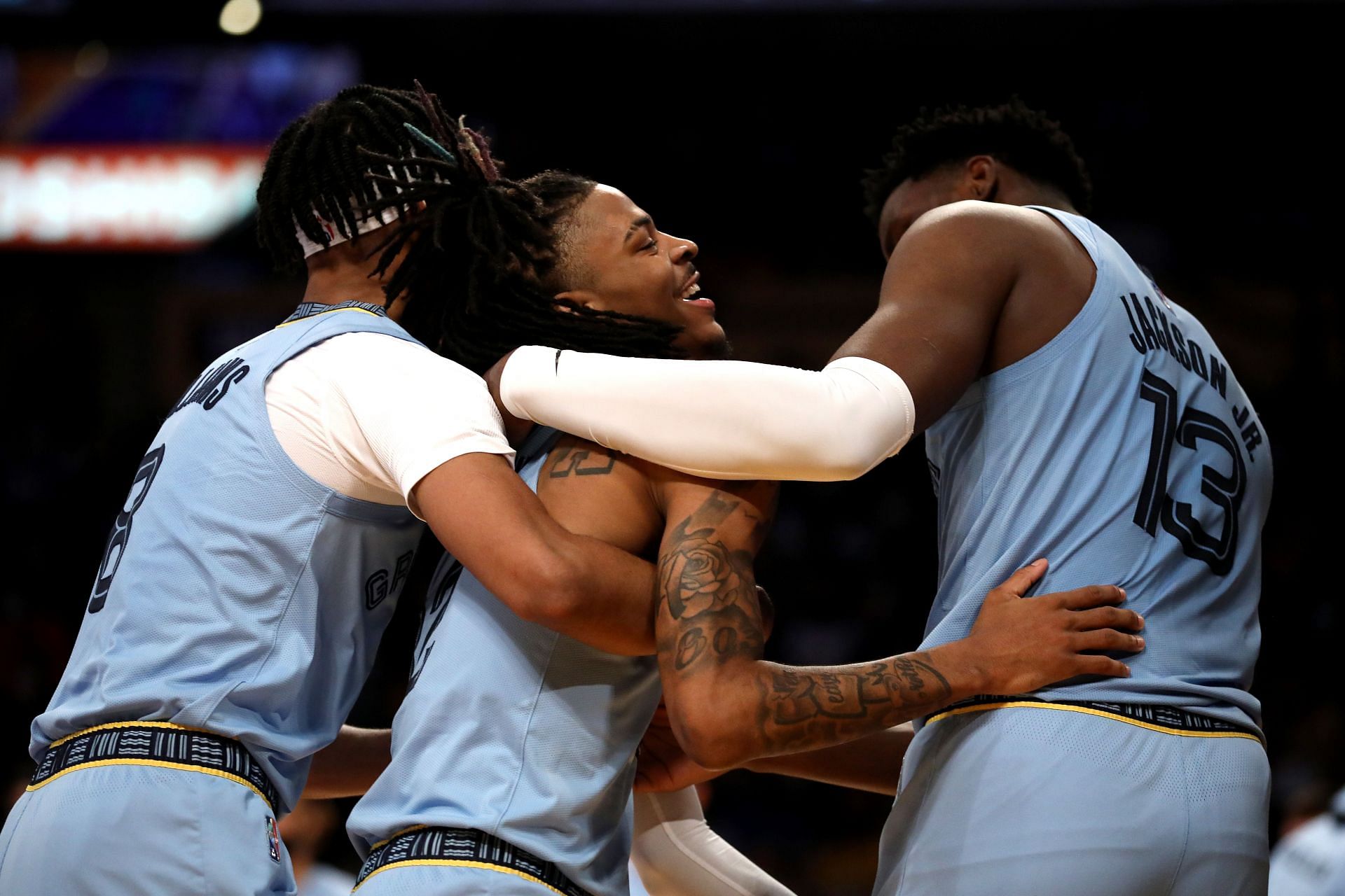 Ja Morant of the Memphis Grizzlies celebrates a basket with Ziaire Williams, left, and Jaren Jackson Jr., right, during the third quarter against the LA Lakers on Sunday in Los Angeles, California.