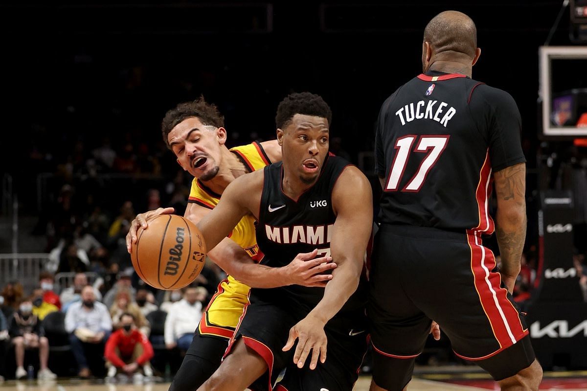 Trae Young of the Atlanta Hawks fights over a screen against Kyle Lowry and PJ Tucker of the Miami Heat
