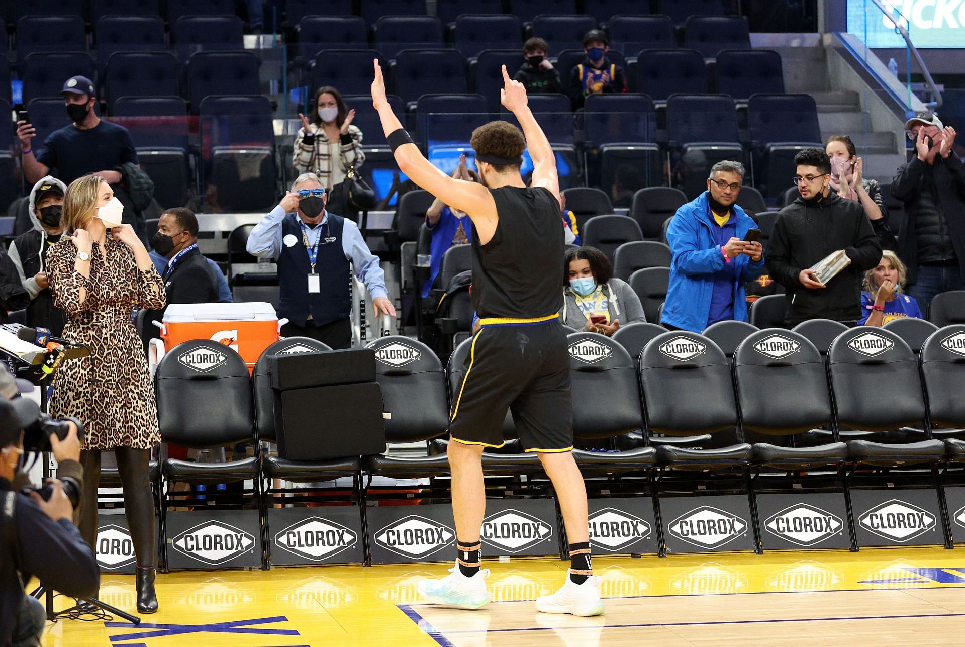 Klay Thompson of the Golden State Warriors signals to the fans after pregame shootaround