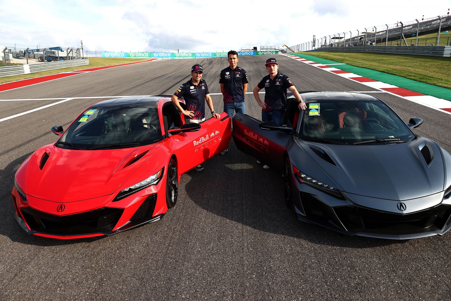 F1 Grand Prix of USA - Max Verstappen and teammates pose in front of Honda supercars