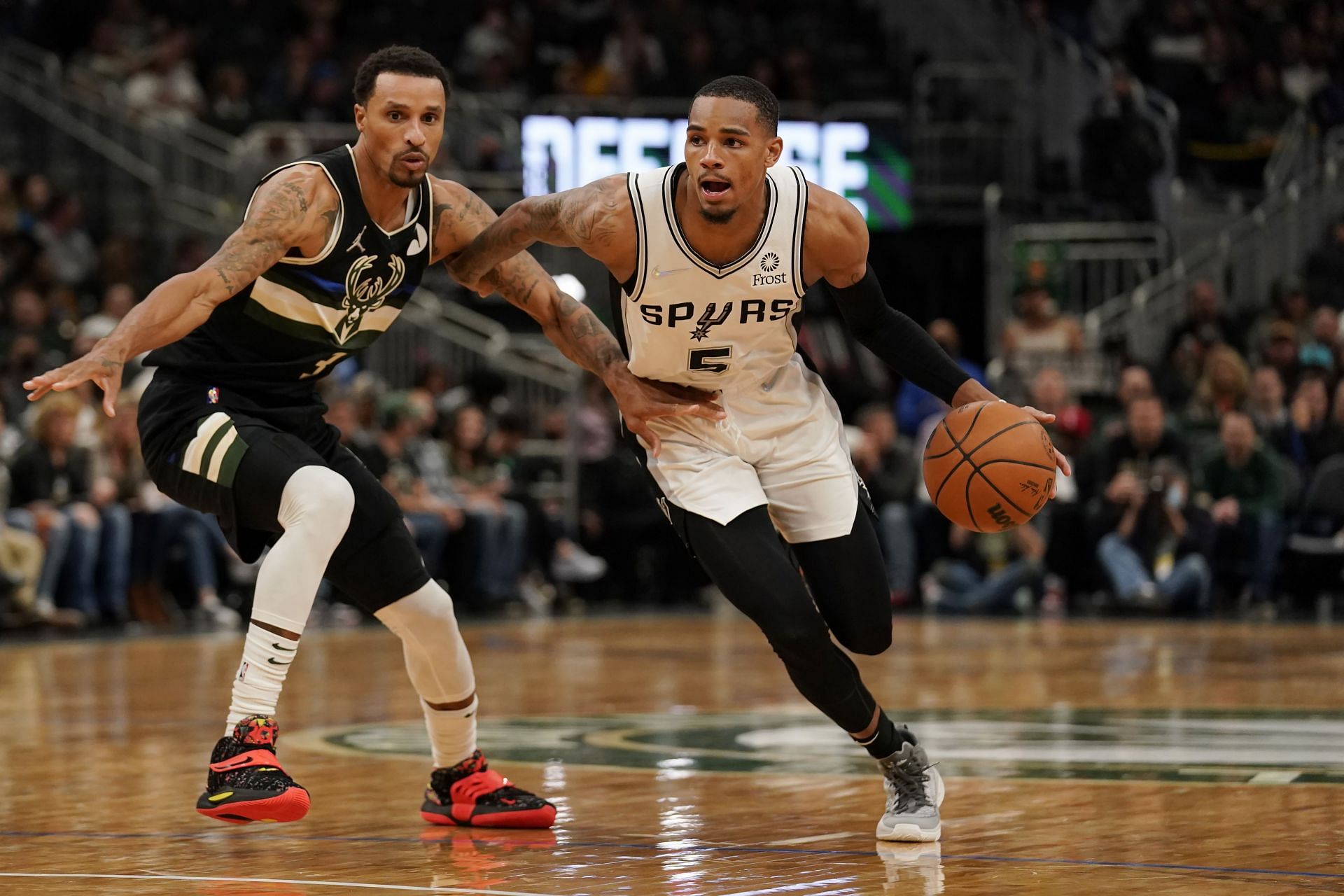Dejounte Murray #5 of the San Antonio Spurs dribbles the ball against George Hill #3 of the Milwaukee Bucks in the second half at Fiserv Forum on October 30, 2021 in Milwaukee, Wisconsin.