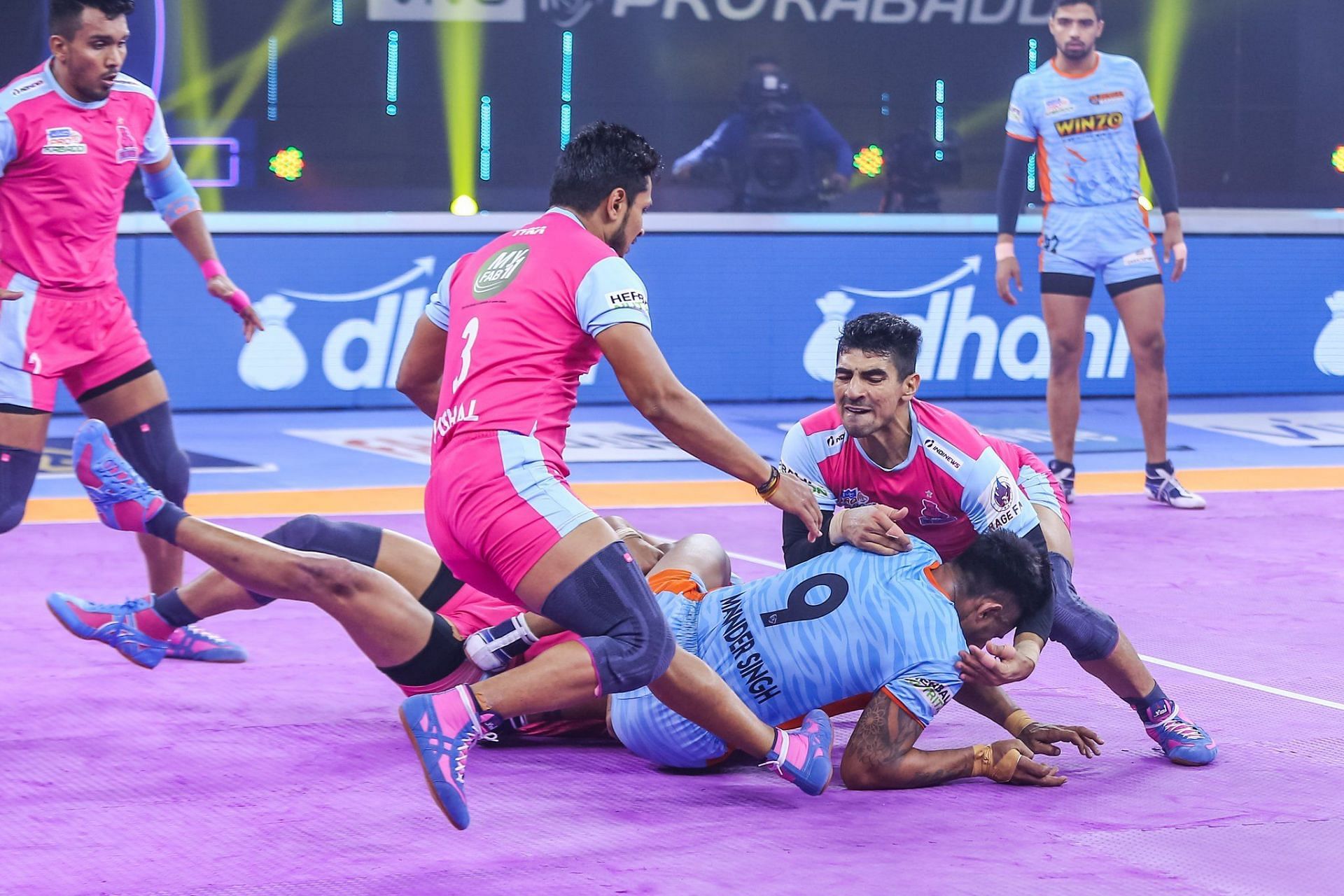 The Jaipur Pink Panthers defenders tackle a Bengal Warriors&#039; defender in their PKL encounter on Thursday - Image Courtesy: Jaipur Pink Panthers Twitter