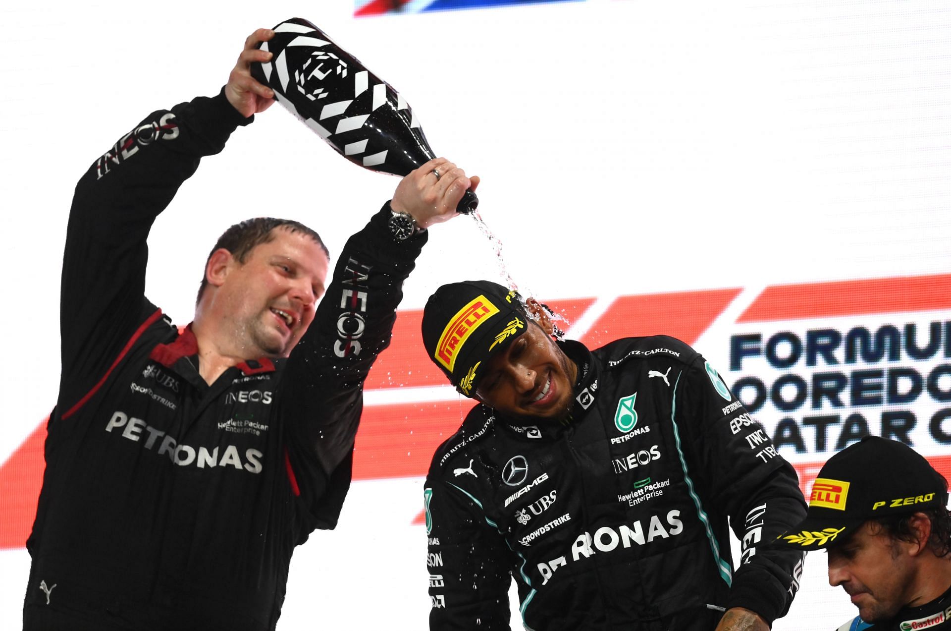 Lewis Hamilton celebrates on the podium of the Qatar Grand Prix (Photo by Clive Mason/Getty Images)