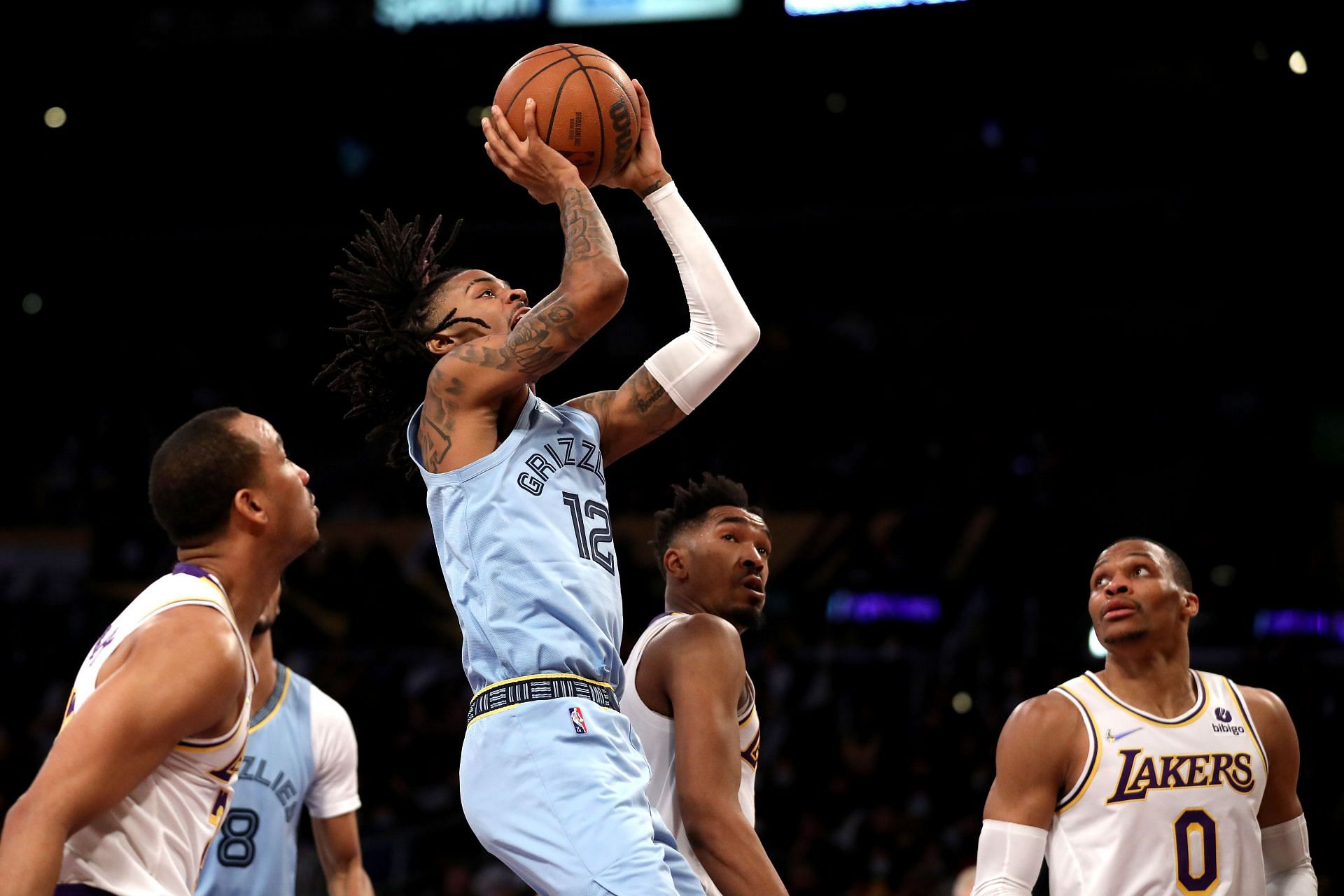Ja Morant #12 of the Memphis Grizzlies shoots the ball against Avery Bradley #20, Malik Monk #11 and Russell Westbrook #0 of the Los Angeles Lakers during the third quarter at Crypto.com Arena on January 09, 2022 in Los Angeles, California.