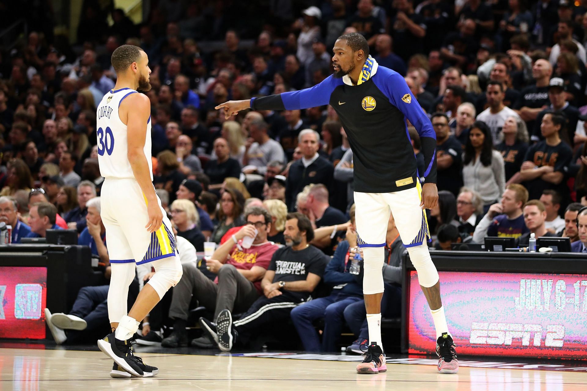 Kevin Durant, right, of the Golden State Warriors reacts with Steph Curry
