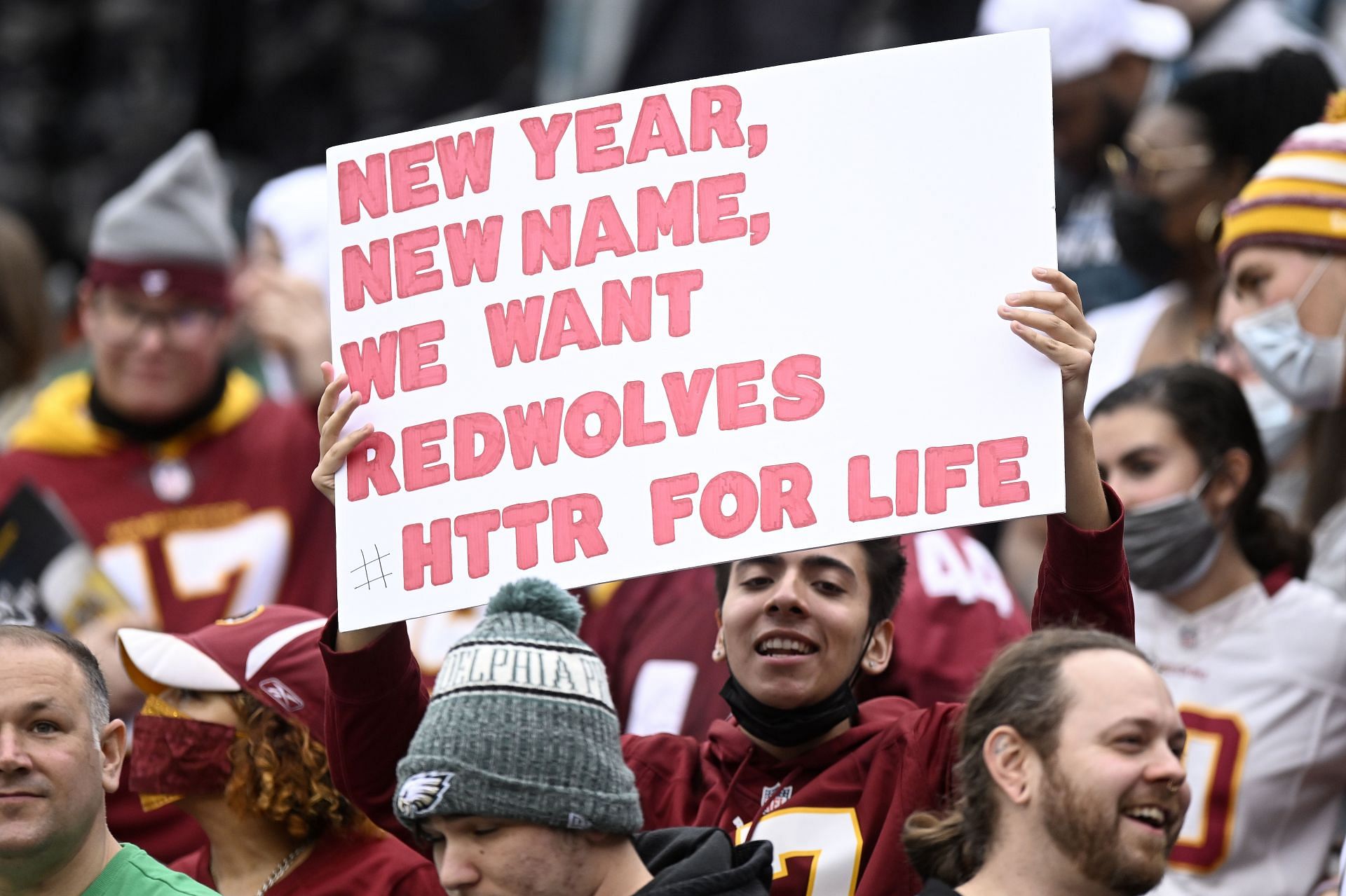 A Washington Football Team holds a sign in support of a new name for the team