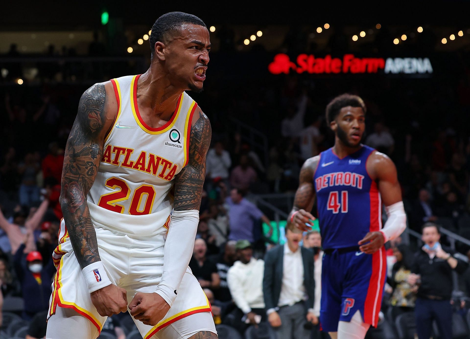 John Collins celebrates a play against the Detroit Pistons.