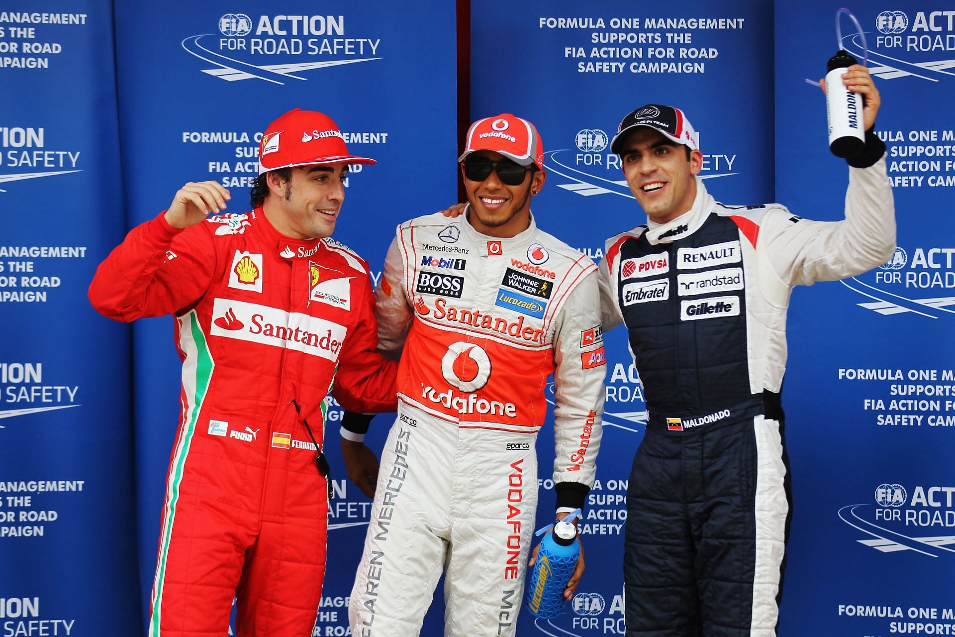 Lewis Hamilton (center) and Pastor Maldonado (right) at the Spanish Grand Prix in 2012