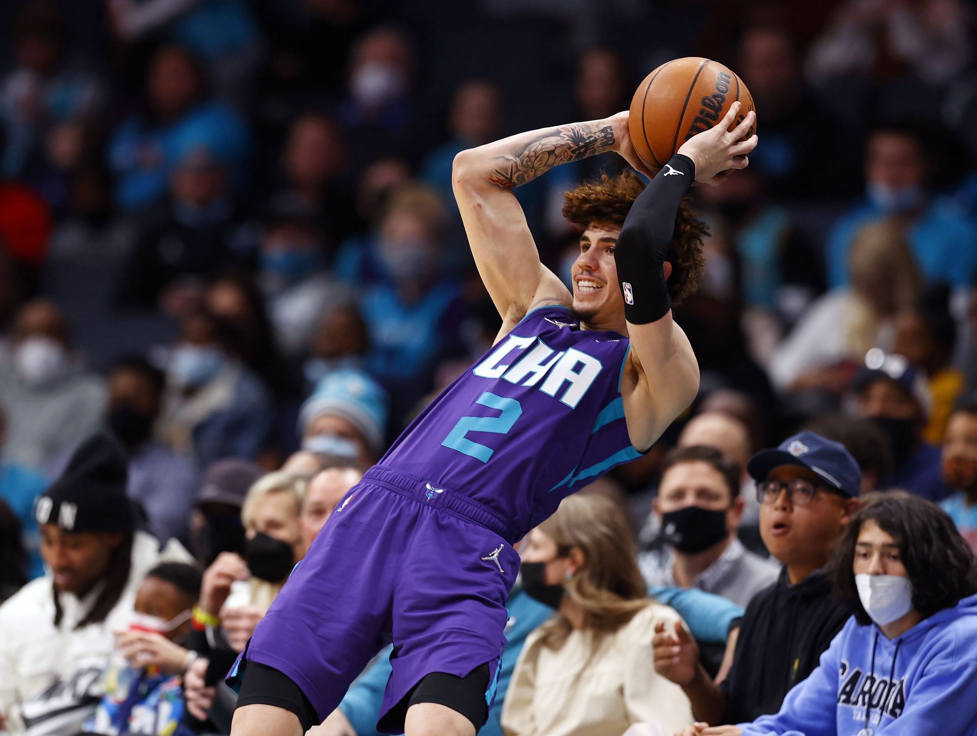 LaMelo Ball attempts to save the ball from going out of bounds.