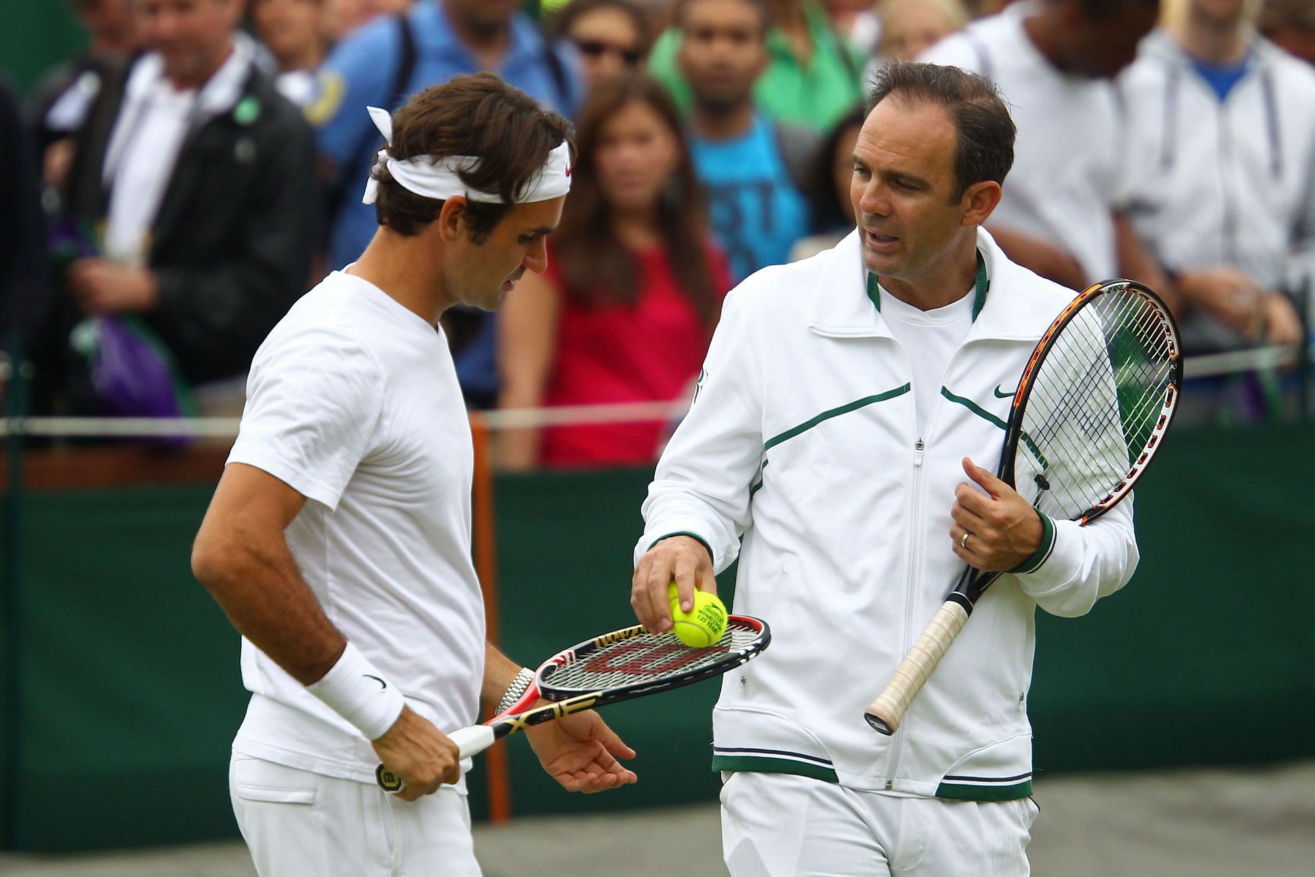 Paul Anancone trains Roger Federer during Wimbledon 2011