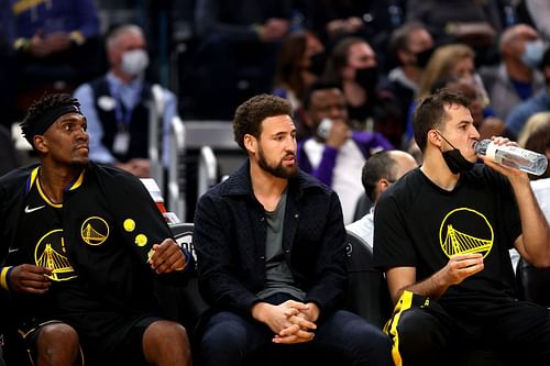 Golden State Warriors star Klay Thompson sitting in street cloths on the becnh