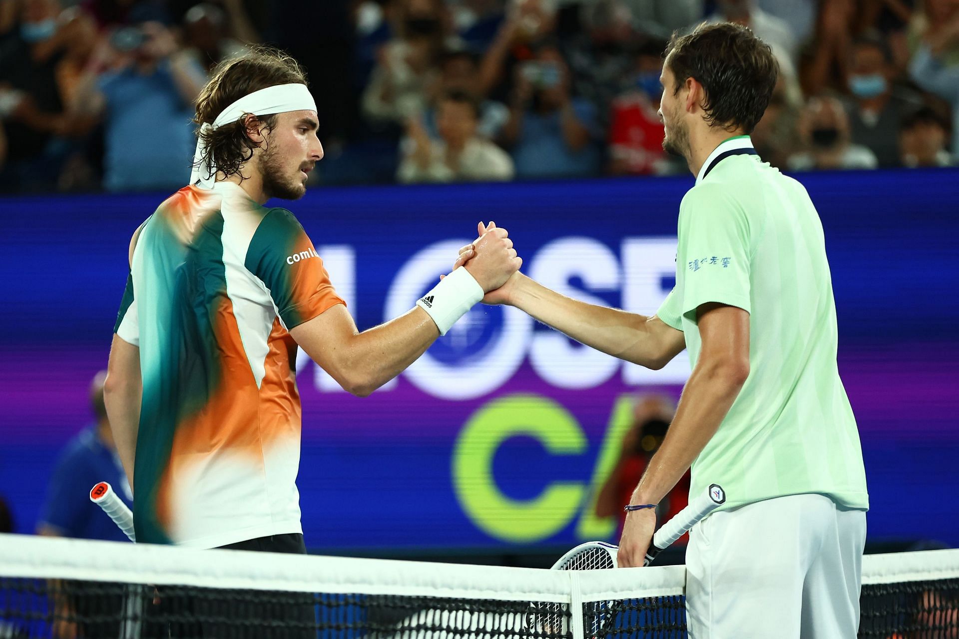 Stefanos Tsitsipas (L) & Daniil Medvedev shake hands after their semifinal at 2022 Australian Open.