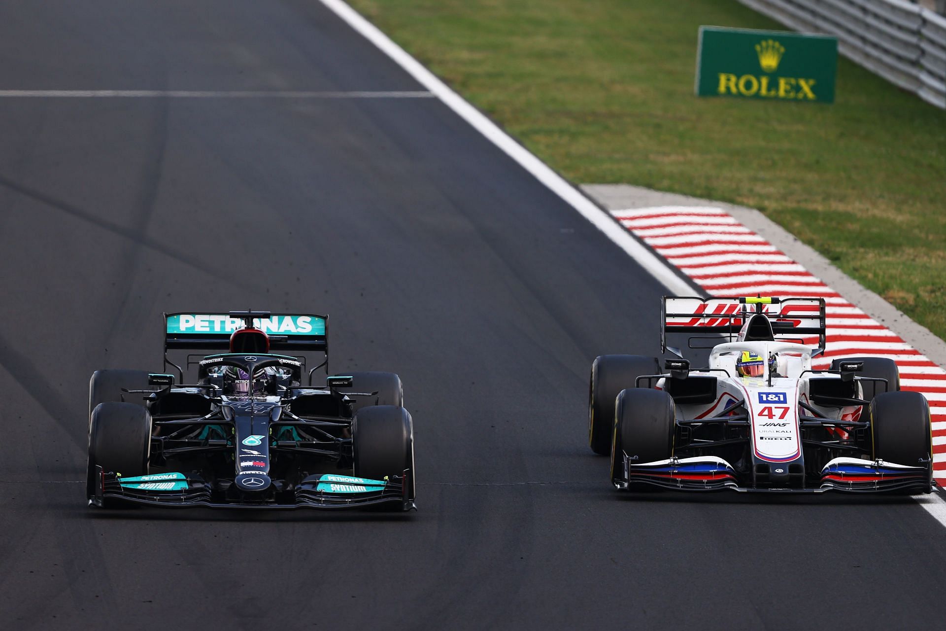 Lewis Hamilton (#44) in his Mercedes W13 overtakes Mick Schumacher (#47) in the Haas VF-21 at the 2021 Hungarian Grand Prix