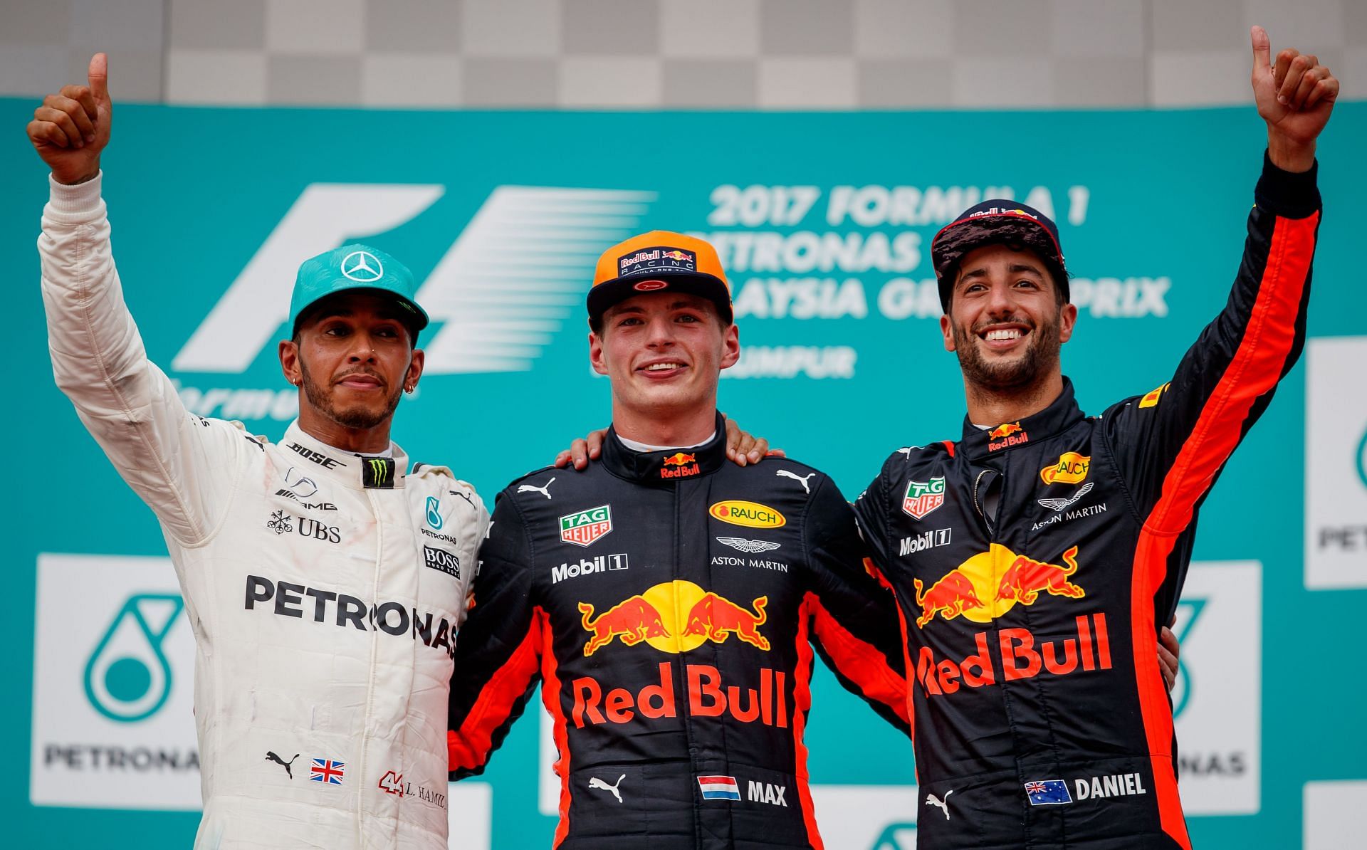 Lewis Hamilton (left), Max Verstappen (center), and Daniel Ricciardo (right) together on the podium at the 2017 Malaysian Grand Prix