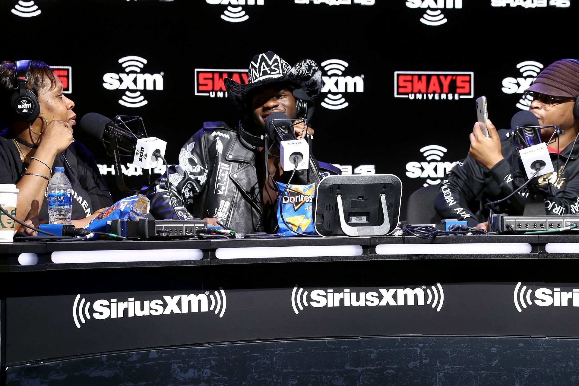 Lil Nas X (center) (Image via Cindy Ord/Getty Images for SiriusXM)