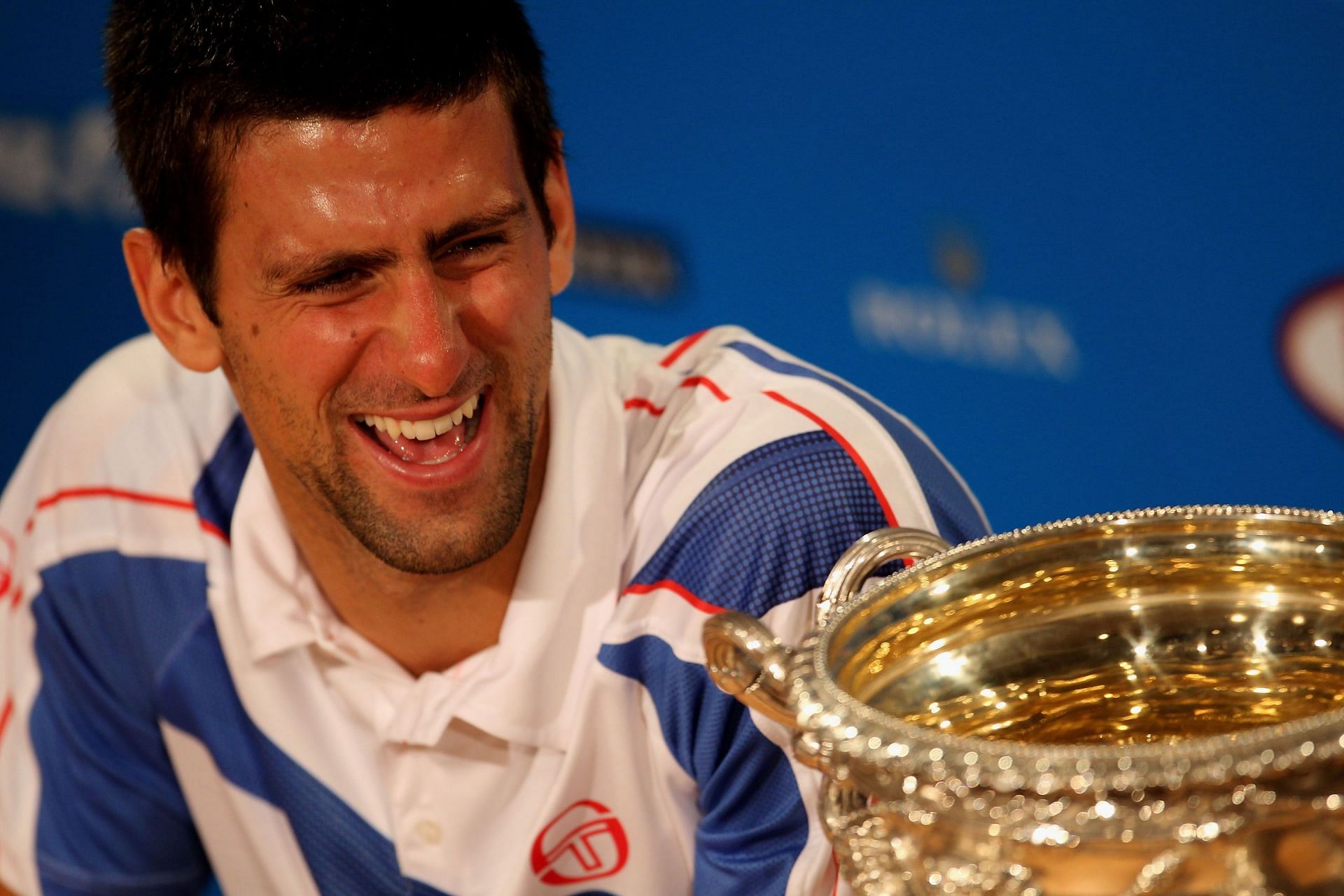 Novak Djokovic poses with the 2011 Australian Open title