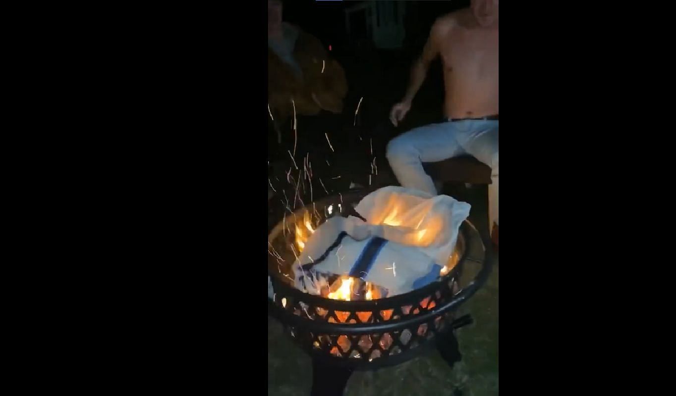 Fan burns his quarterback&#039;s jersey after playoff loss - Credit: Old Row Sports