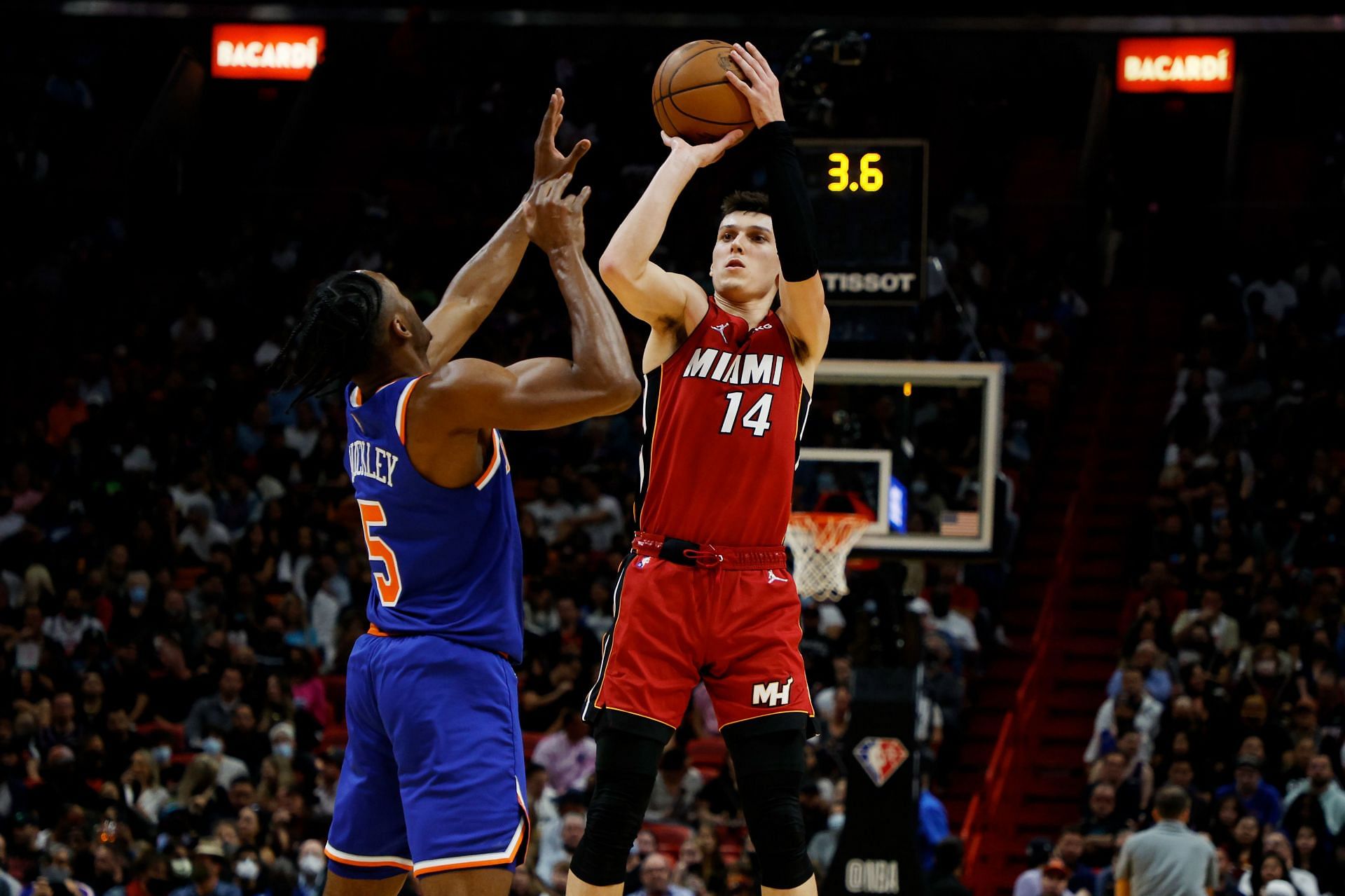 Miami Heat's Tyler Herro attempts a shot over Immanuel Quickley.