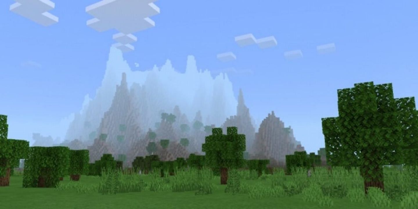 A forest biome rests in the foreground with a mountain biome in the distance (Image via Mojang)