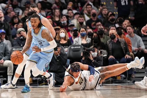 Ja Morant of the Memphis Grizzlies dribbles away from Aaron Gordon of the Denver Nuggets at Ball Arena on January 21 in Denver, Colorado.