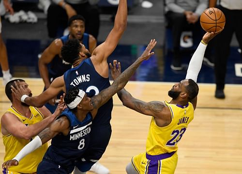 Karl-Anthony Towns of the Minnesota Timberwolves tries to block LA Lakers' LeBron James