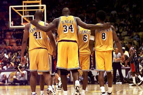 Los Angeles Lakers #34 Shaquille O’Neal puts his arms around teammates including #8 Kobe Bryant [Image Credit: Associated Press]