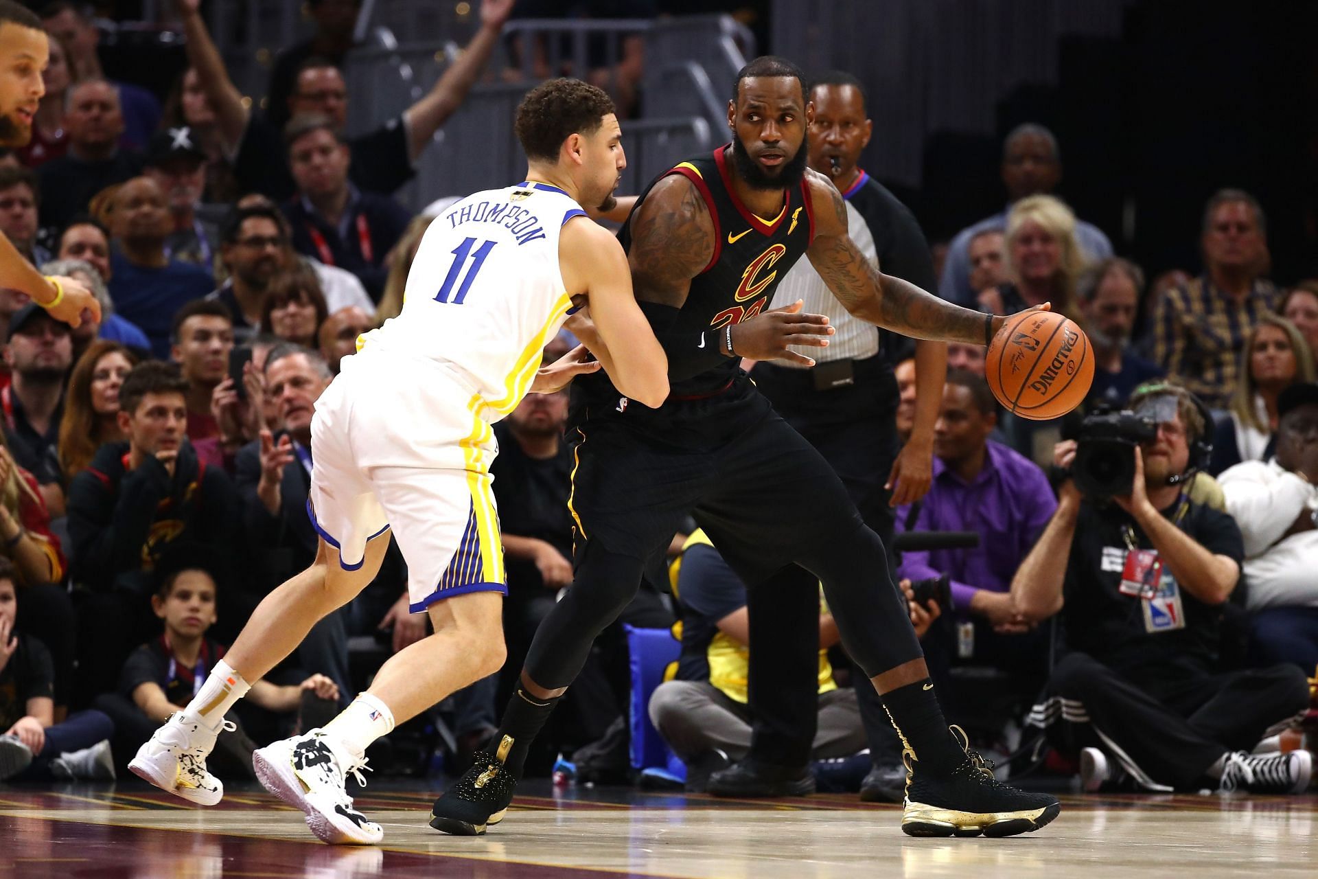 LeBron James #23 of the Cleveland Cavaliers handles the ball against Klay Thompson #11 of the Golden State Warriors