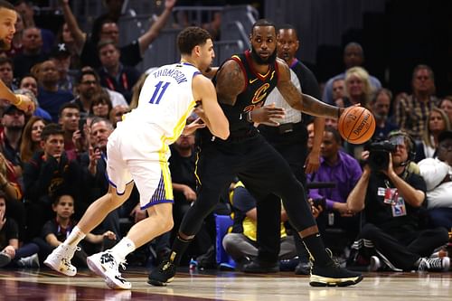 LeBron James #23 of the Cleveland Cavaliers handles the ball against Klay Thompson #11 of the Golden State Warriors