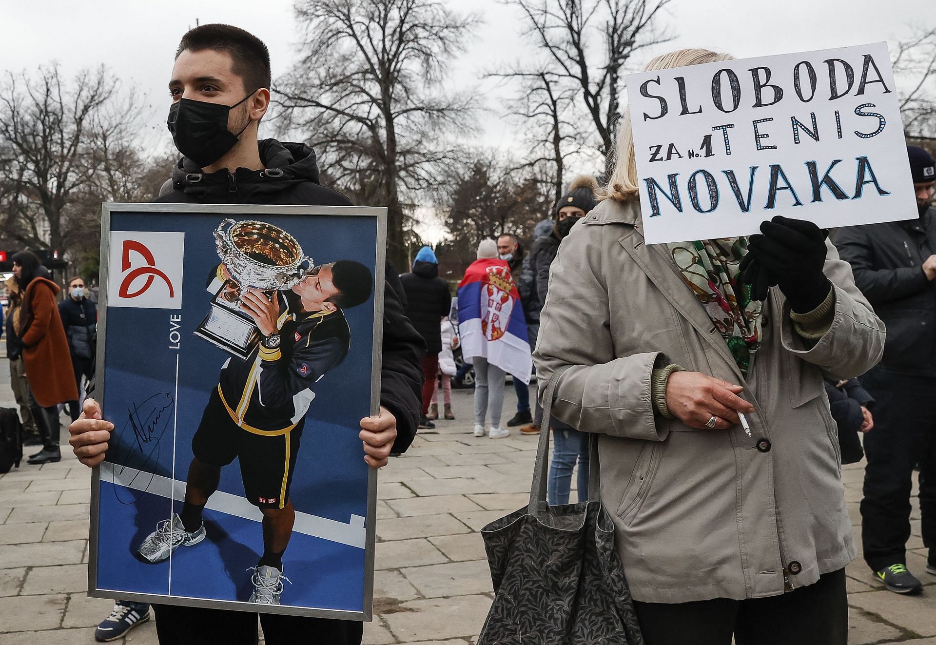 Demonstrators with placards in support of Djokovic