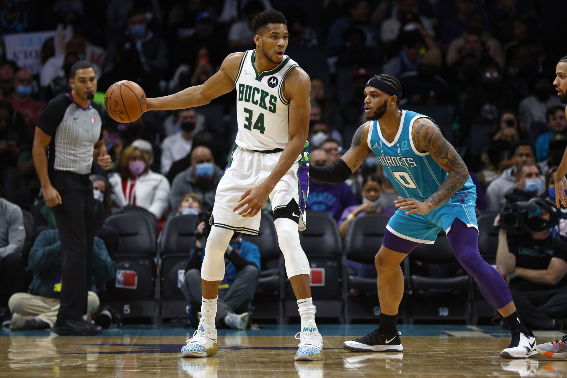 Giannis Antetokounmpo #34 of the Milwaukee Bucks posts up against Miles Bridges #0 of the Charlotte Hornets during the second half of the game at Spectrum Center on January 10, 2022 in Charlotte, North Carolina.