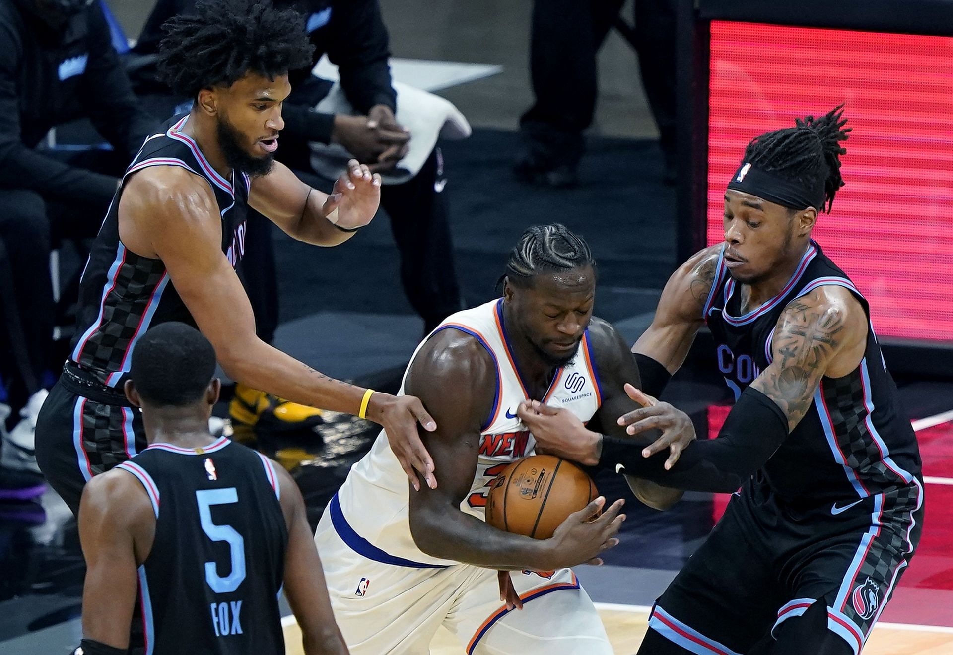 Julius Randle of the New York Knicks against the Sacramento Kings as De&#039;Aaron Fox looks on