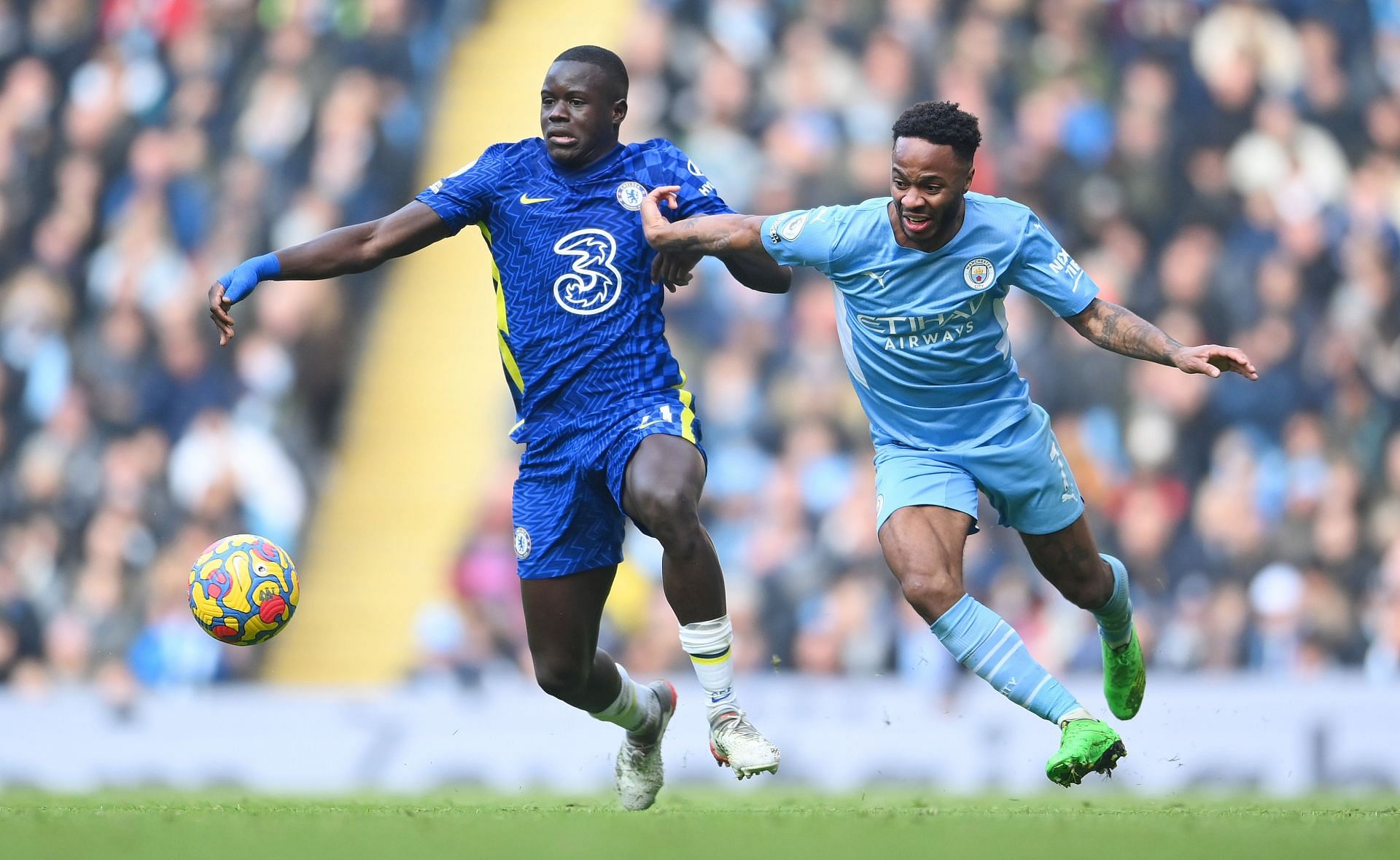 Raheem Sterling tussles it out against Malang Sarr.